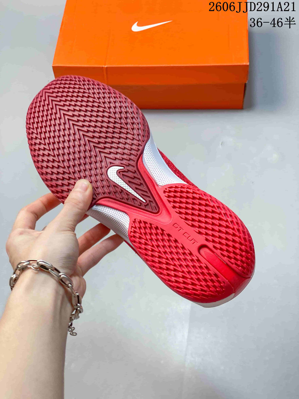 Underside of a red basketball shoe showing a patterned outsole and G.T. Cut branding.