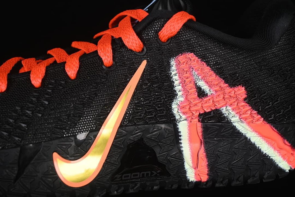Close-up of the side graphics, textured upper, and orange-accented swoosh.