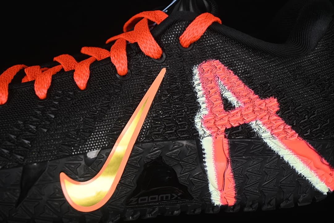 Close-up of the side graphics, textured upper, and orange-accented swoosh.