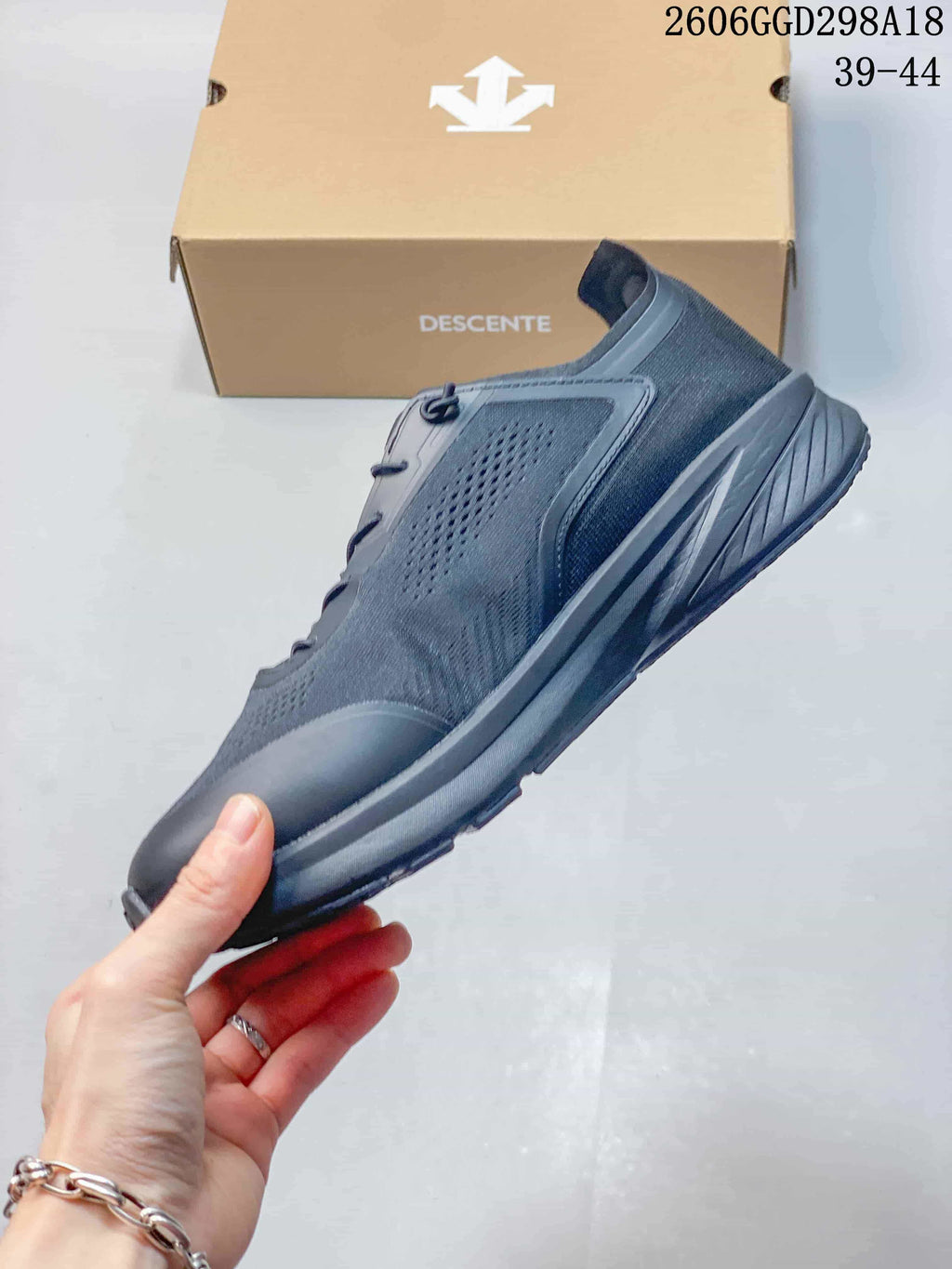 Side view of the dark gray low-top sneaker with perforated panels