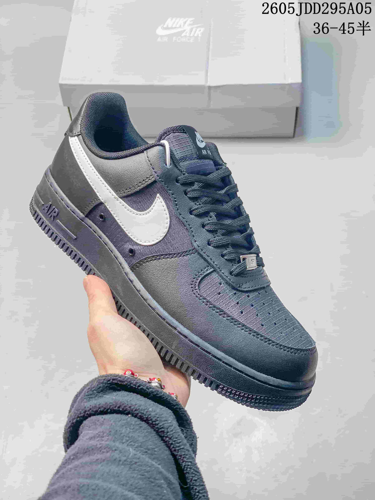Dark gray Nike Air Force 1 low-top sneaker with tonal dark sole and white Swoosh