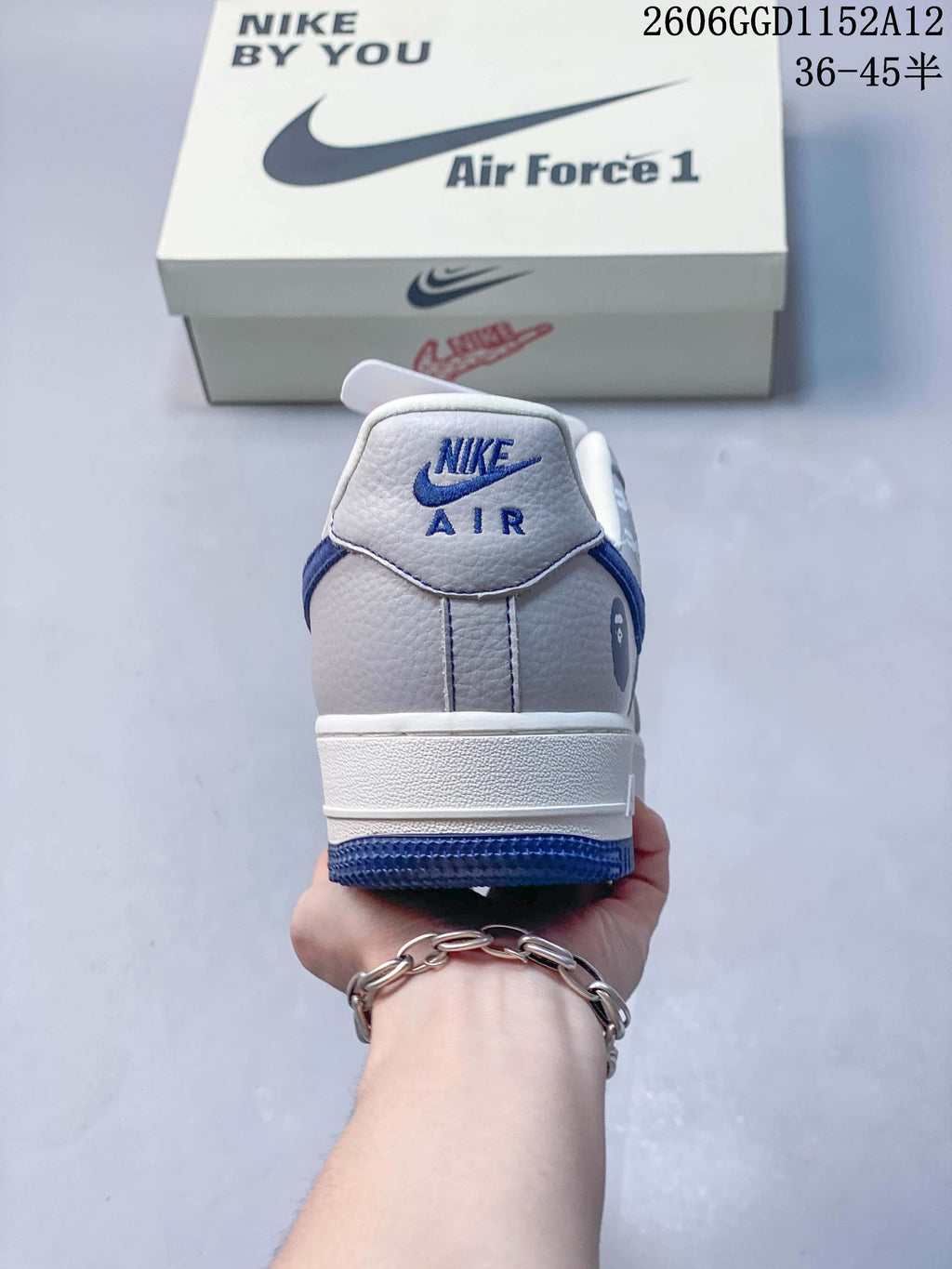 Rear view of the sneaker showing Nike Air lettering and navy blue heel accents