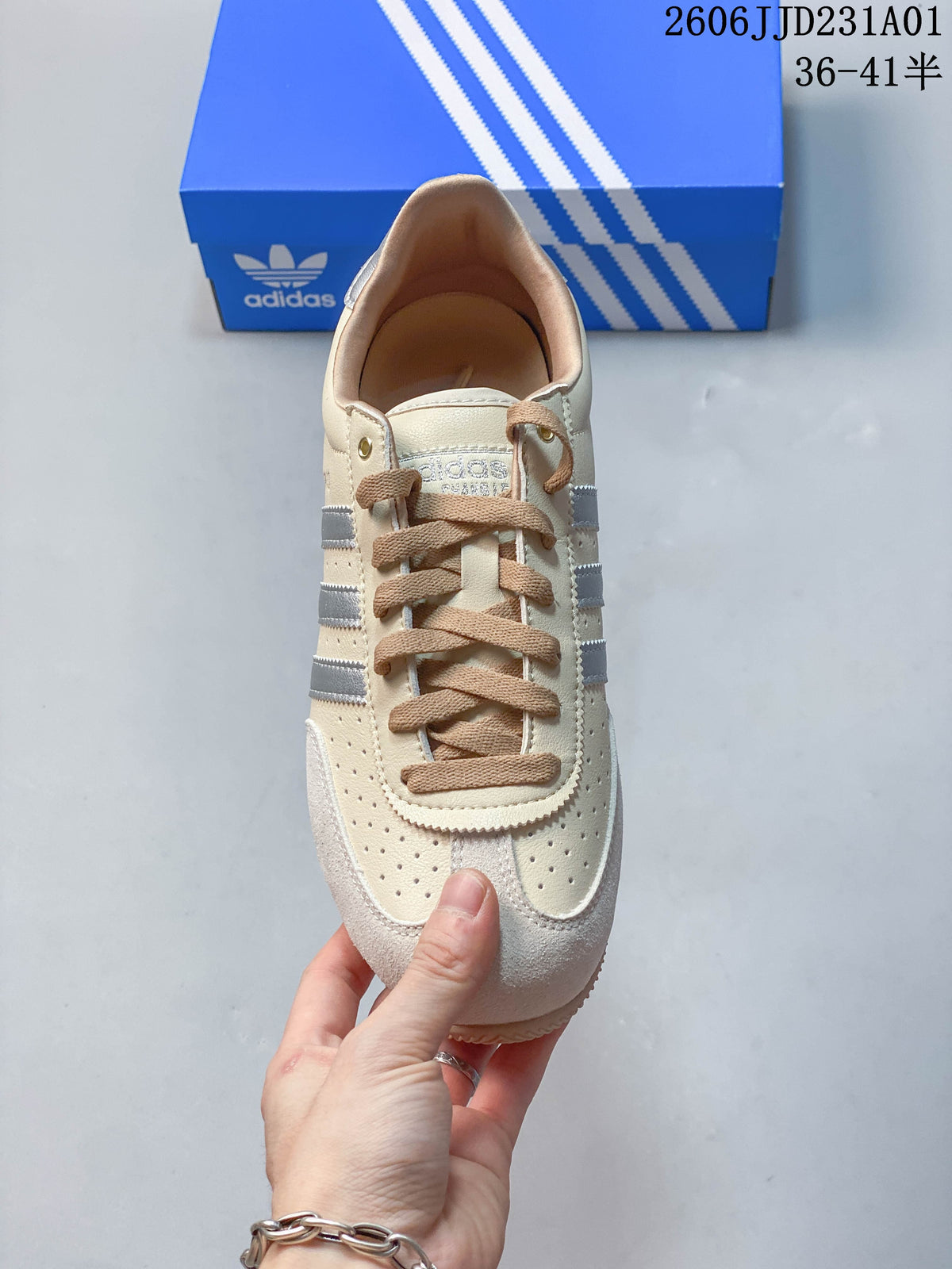 Top view of a cream low-top sneaker showing tan laces and perforations