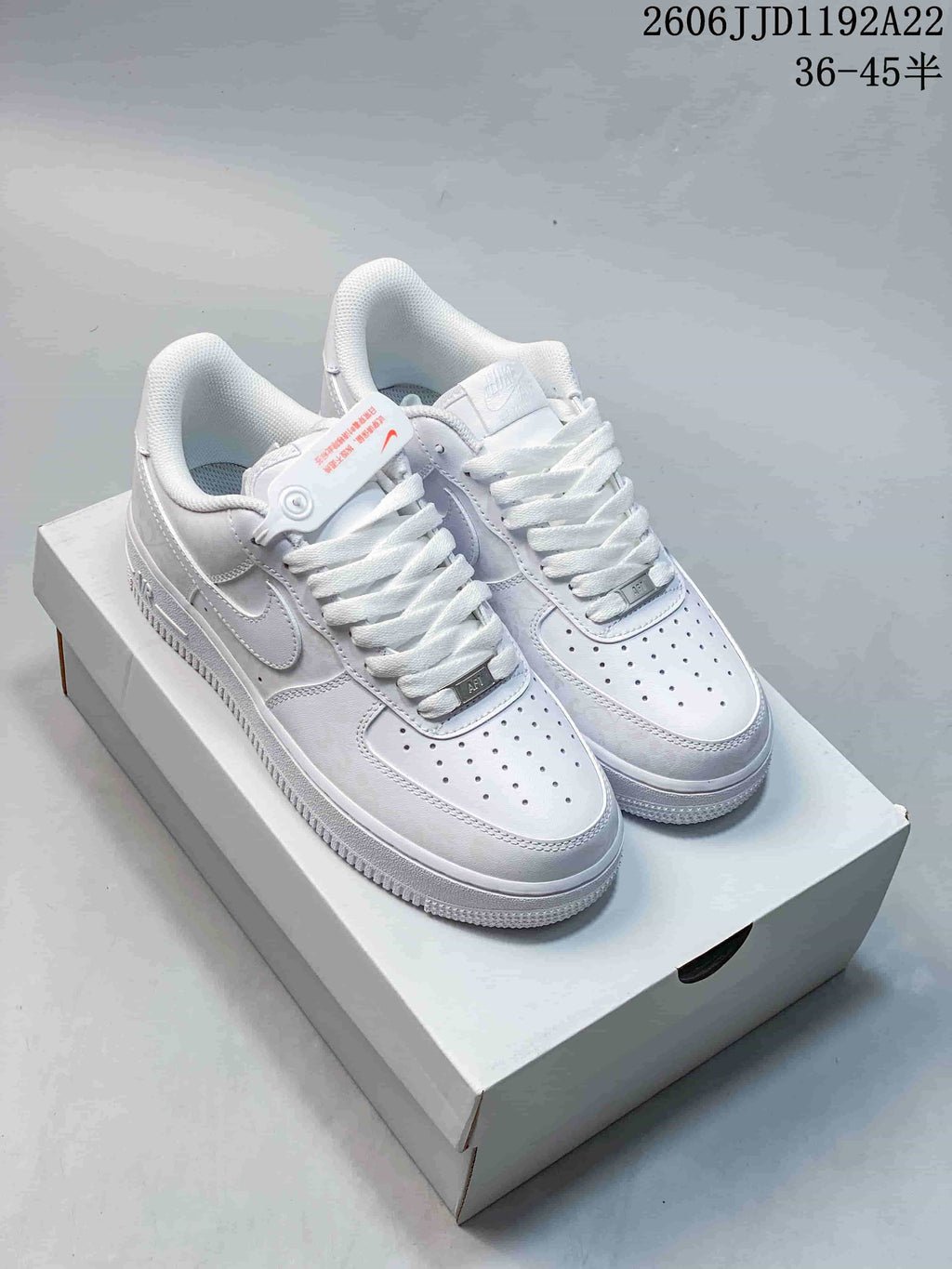 Three low-top sneakers shown in white, cream with a dark swoosh, and charcoal gray with orange accents