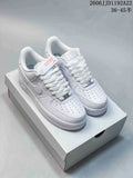 Three low-top sneakers shown in white, cream with a dark swoosh, and charcoal gray with orange accents