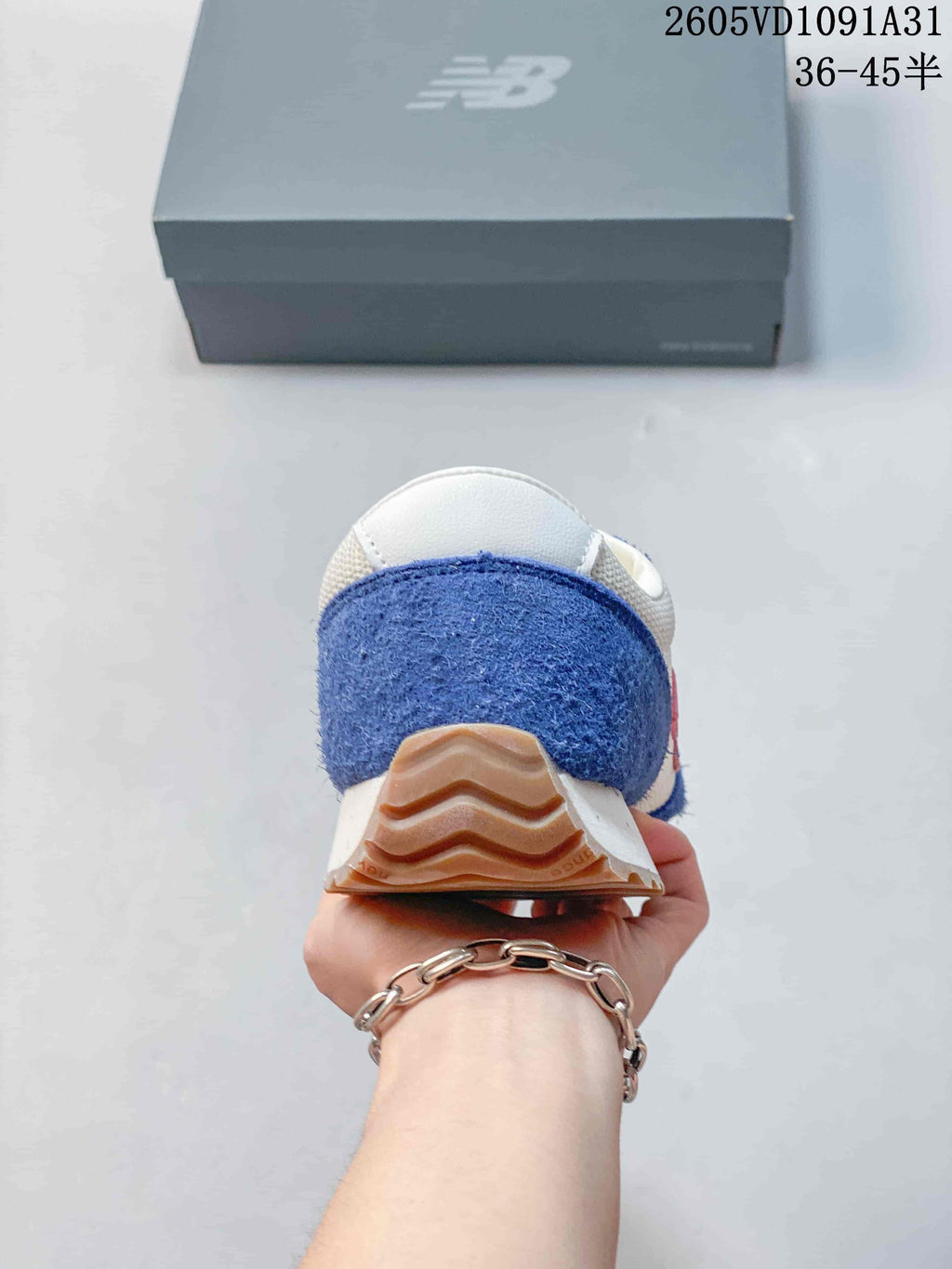 Rear view showing the blue heel overlay and gum-colored outsole