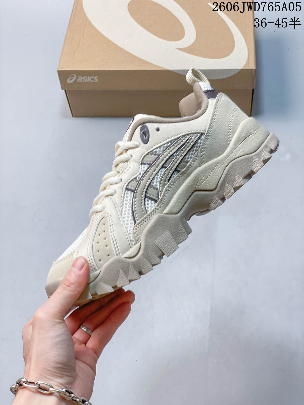 Side profile showing the layered upper and chunky outsole of a cream ASICS Gel-TRUCK sneaker