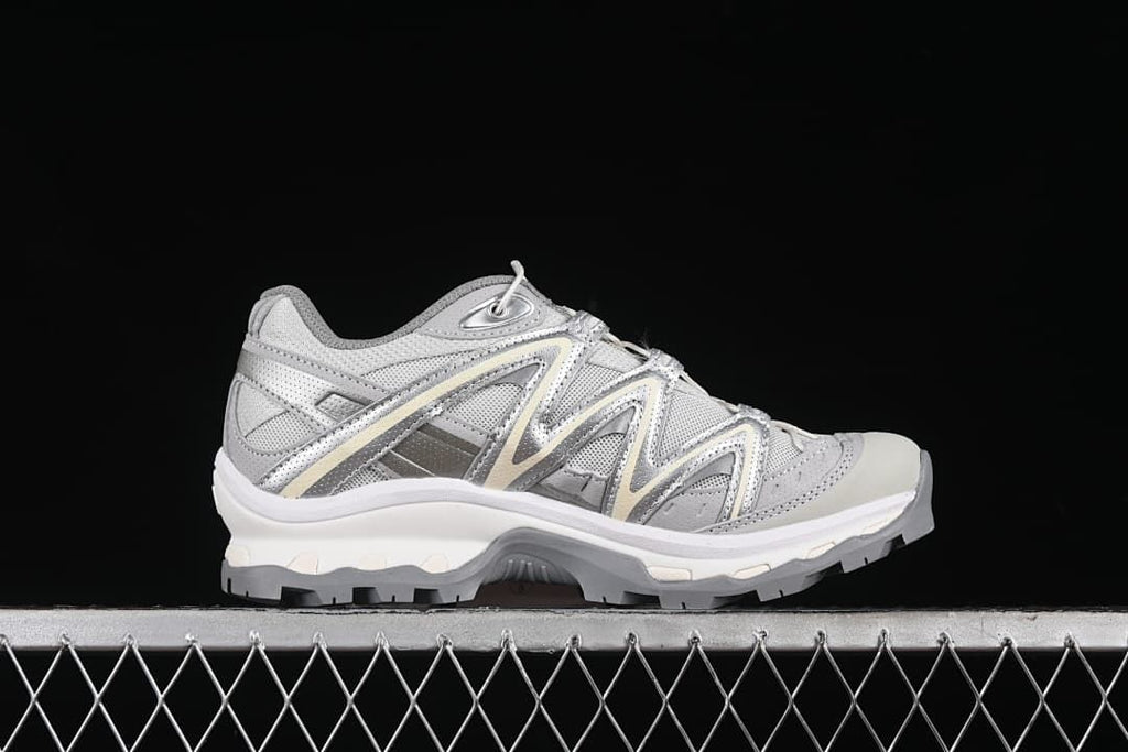 Side profile of one silver-gray sneaker.