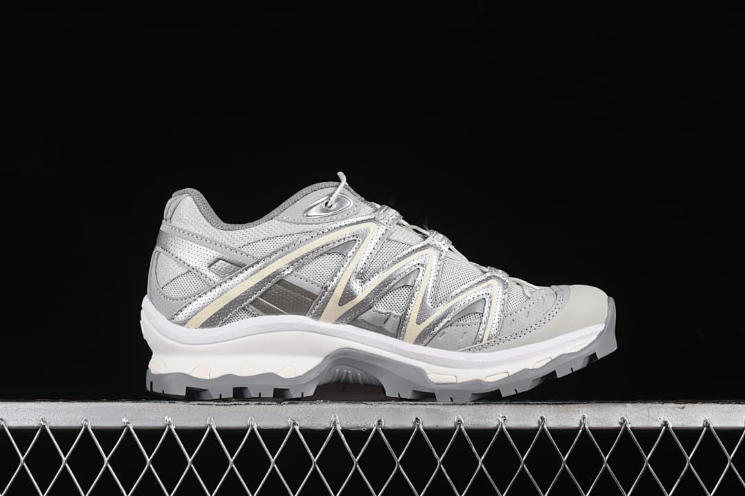 Side profile of one silver-gray sneaker.