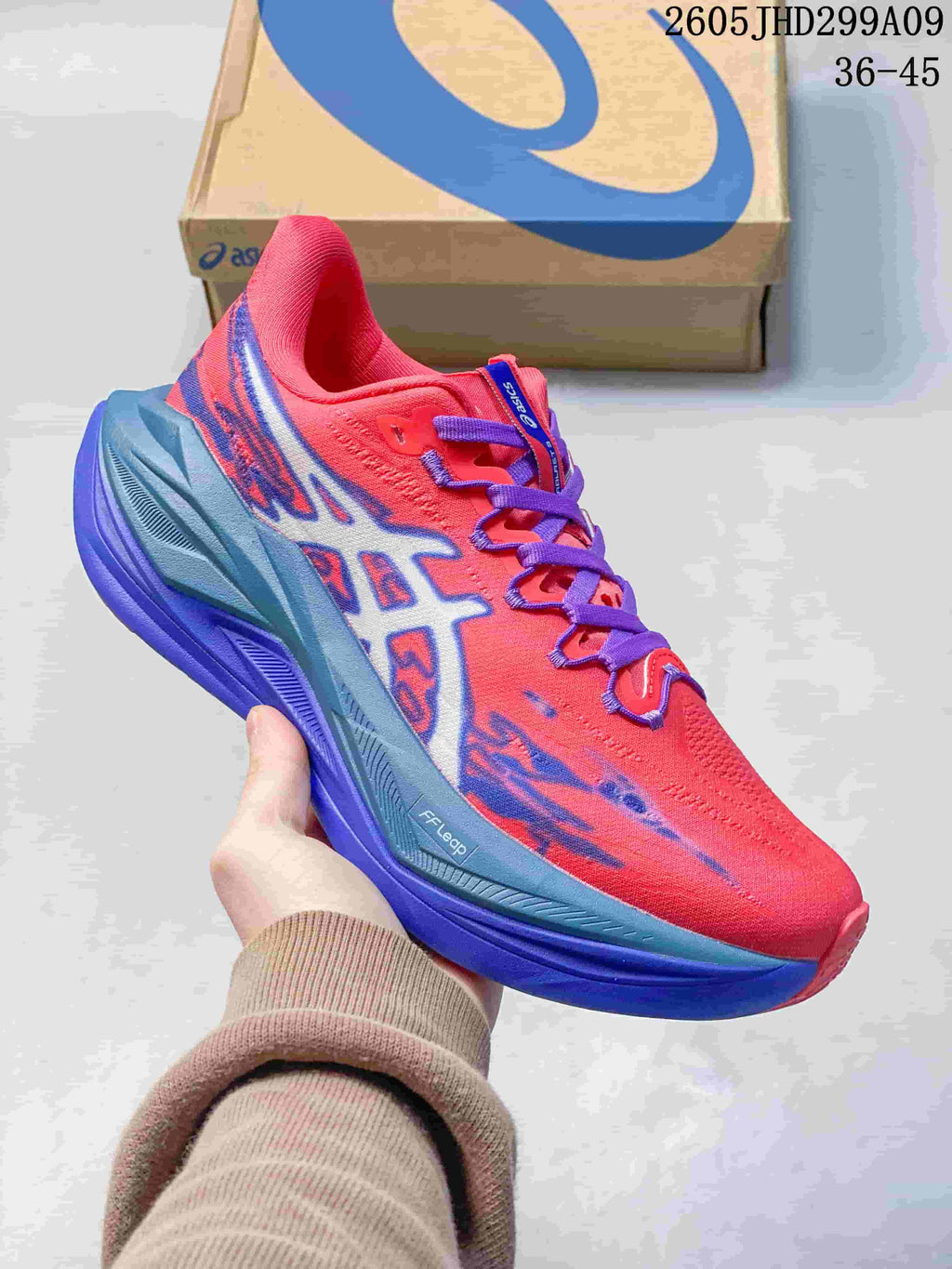 Coral red ASICS Superblast 3 running shoe with purple accents
