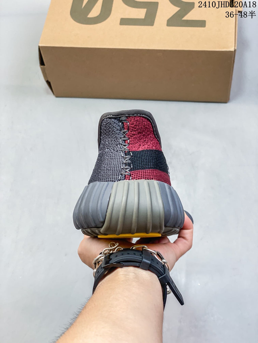 Rear view of the gray and red sneakers showing the ribbed heel sole