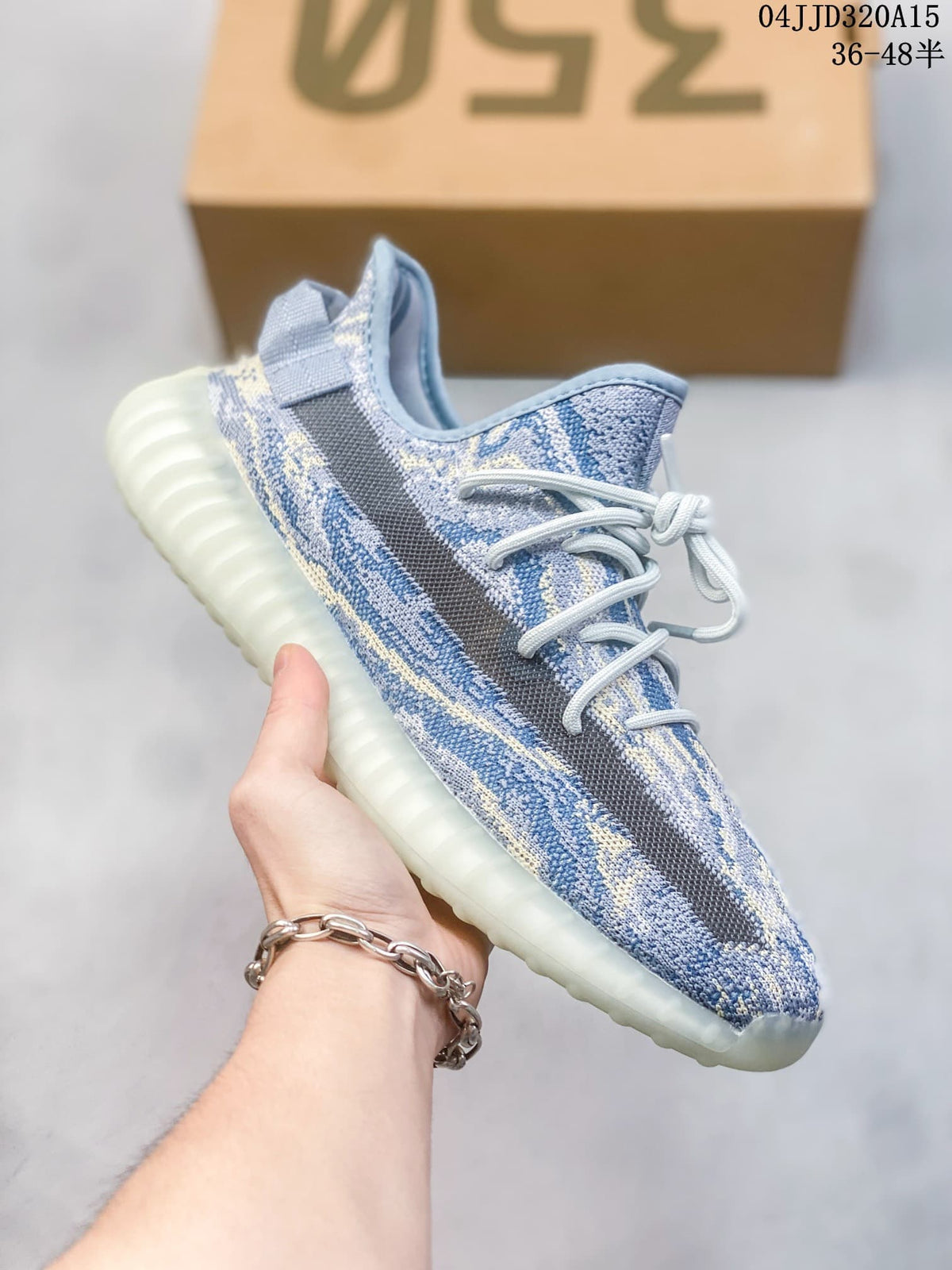Side view of a blue and cream patterned Yeezy Boost 350-style sneaker with a ribbed pale sole.