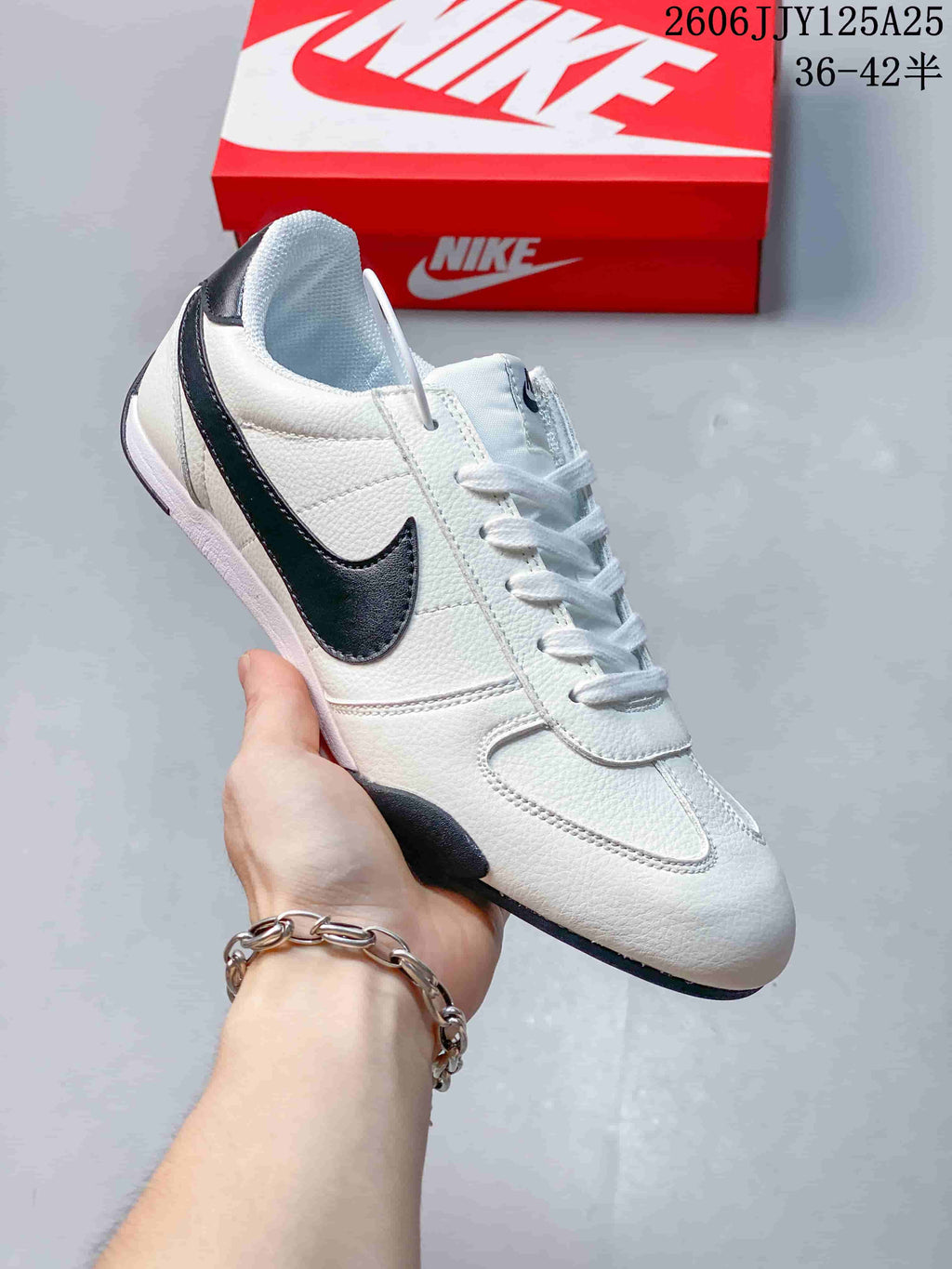 Side view of a white Nike Sprint Sister sneaker with a black Swoosh