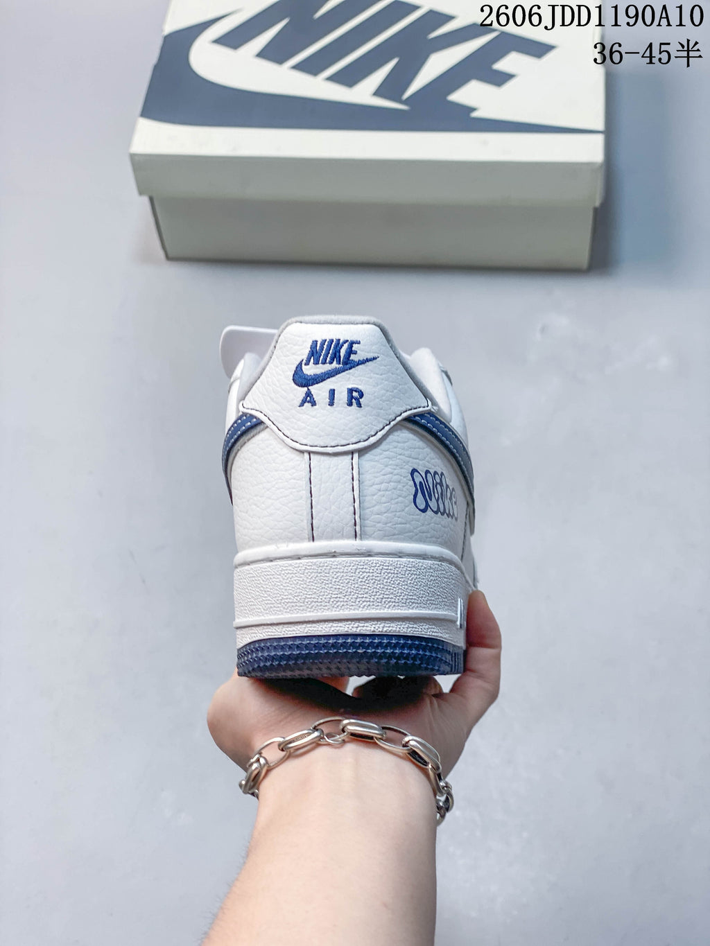 Rear view of the white sneaker with blue heel details