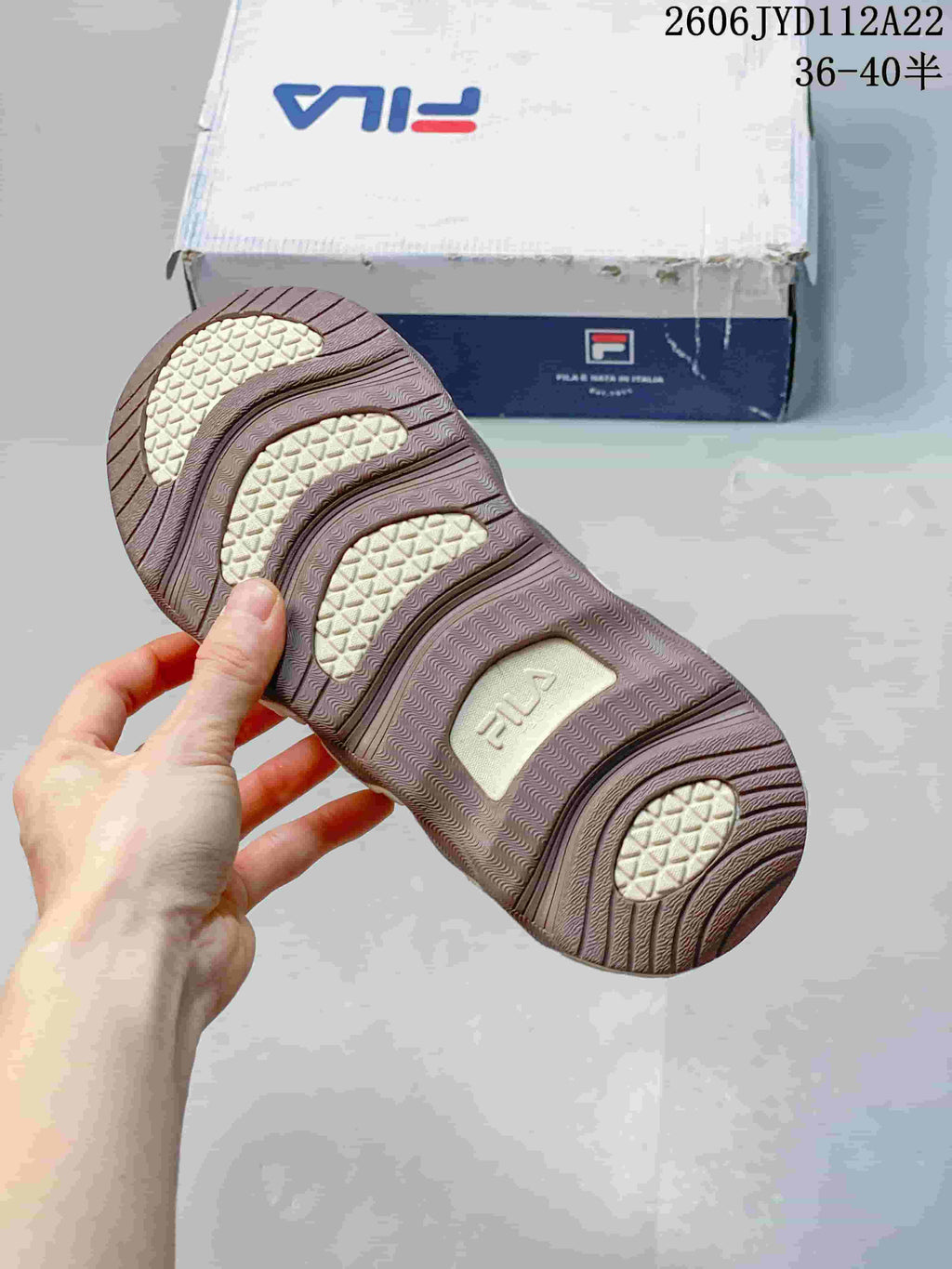 Close-up of the patterned outsole and shoebox