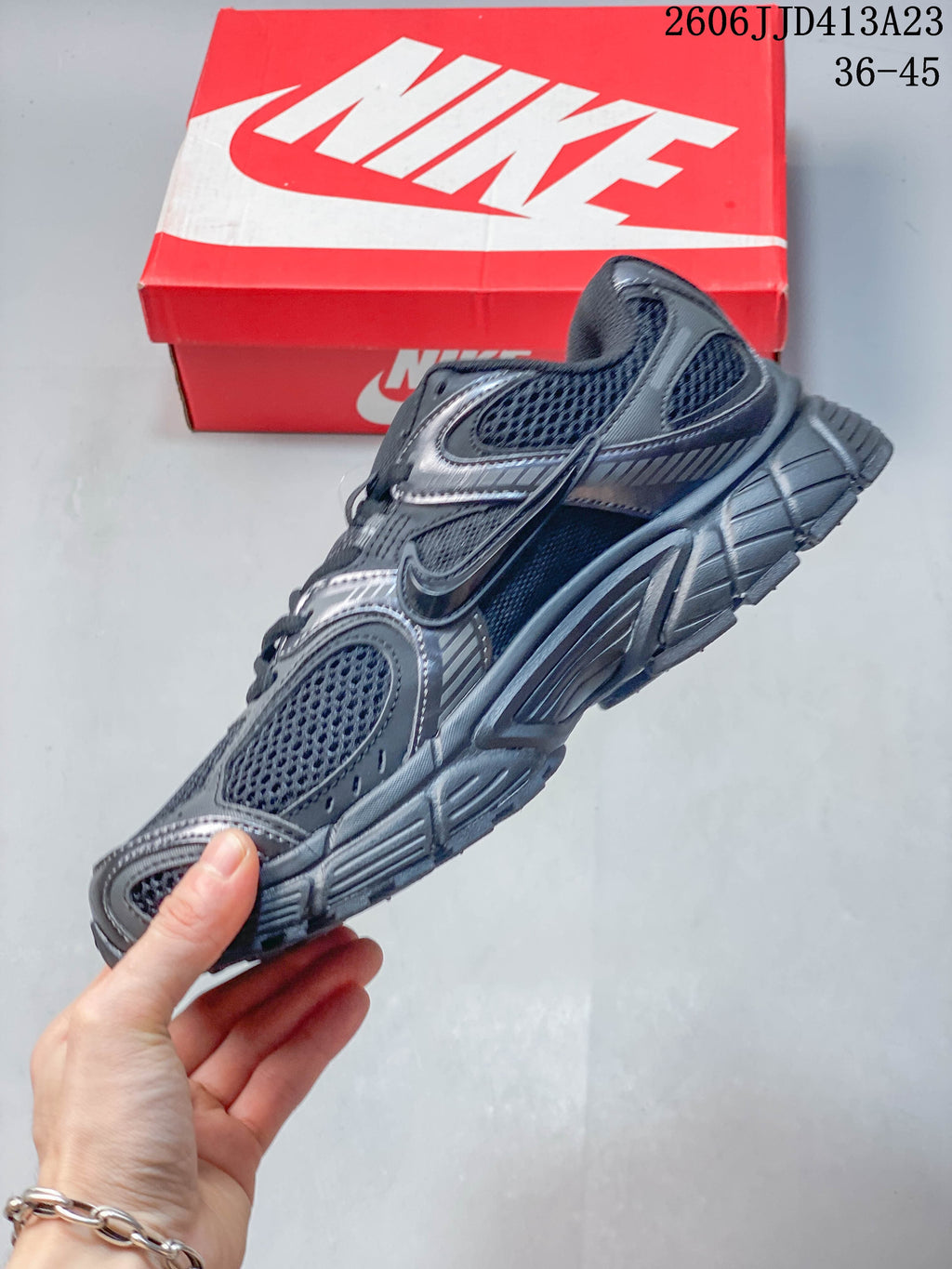 Side profile of a dark charcoal Nike Air Zoom Winflo 12 shoe