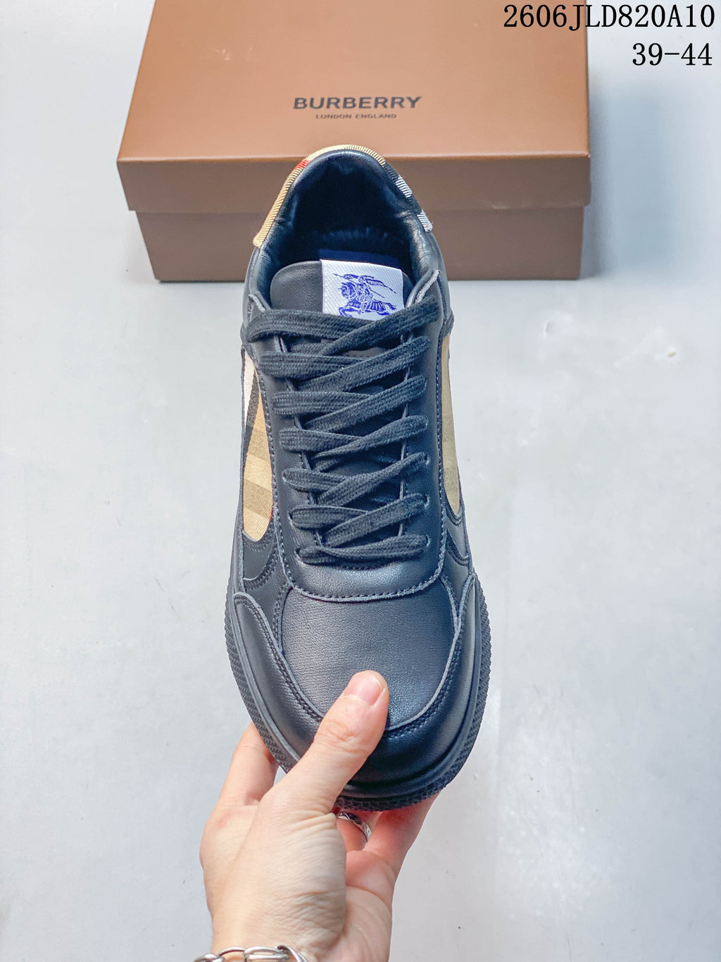 Top view of a navy lace-up sneaker showing its rounded toe and check-pattern accents