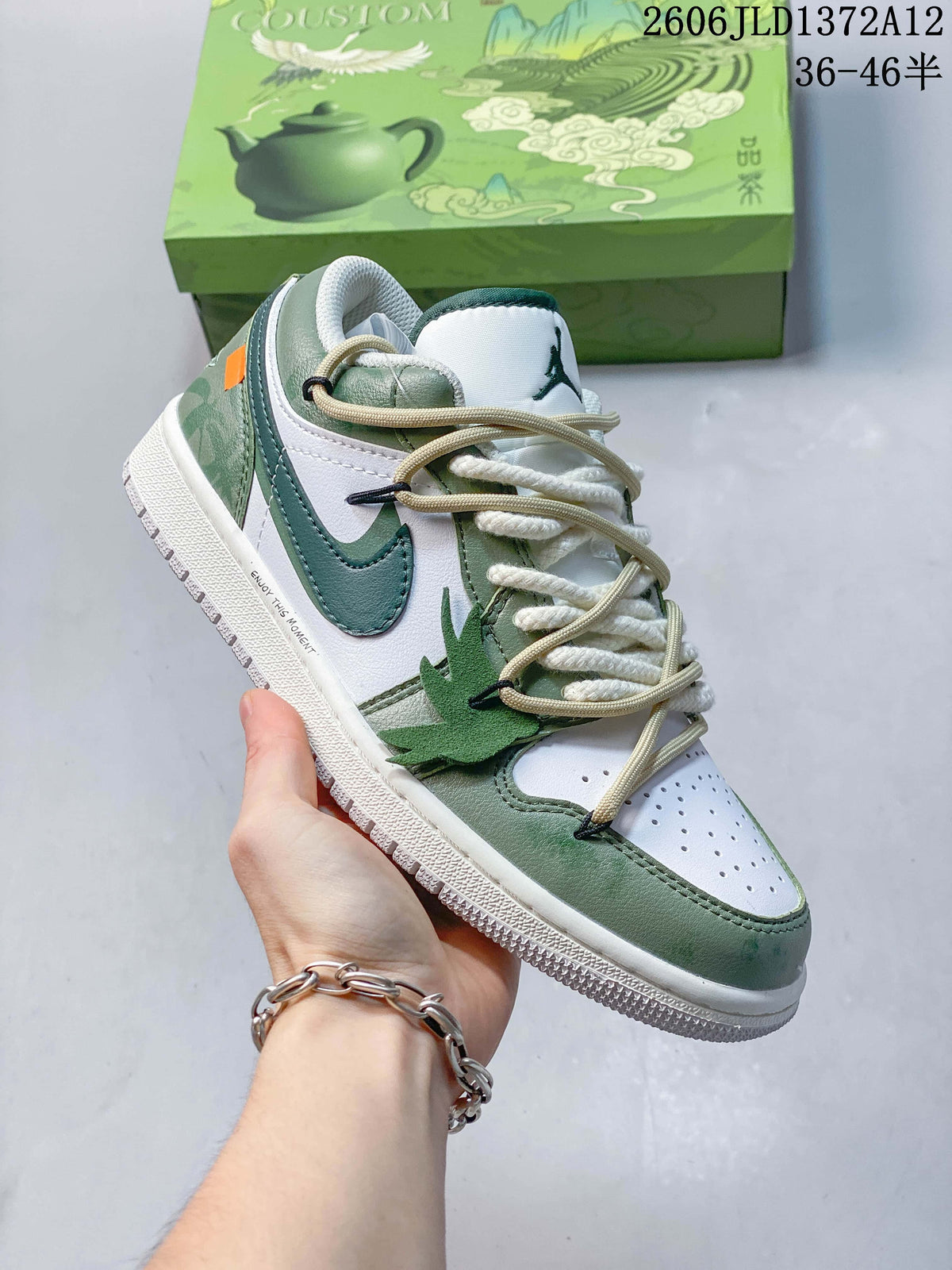 Angled side view of a white and green low-top sneaker with a teal Swoosh