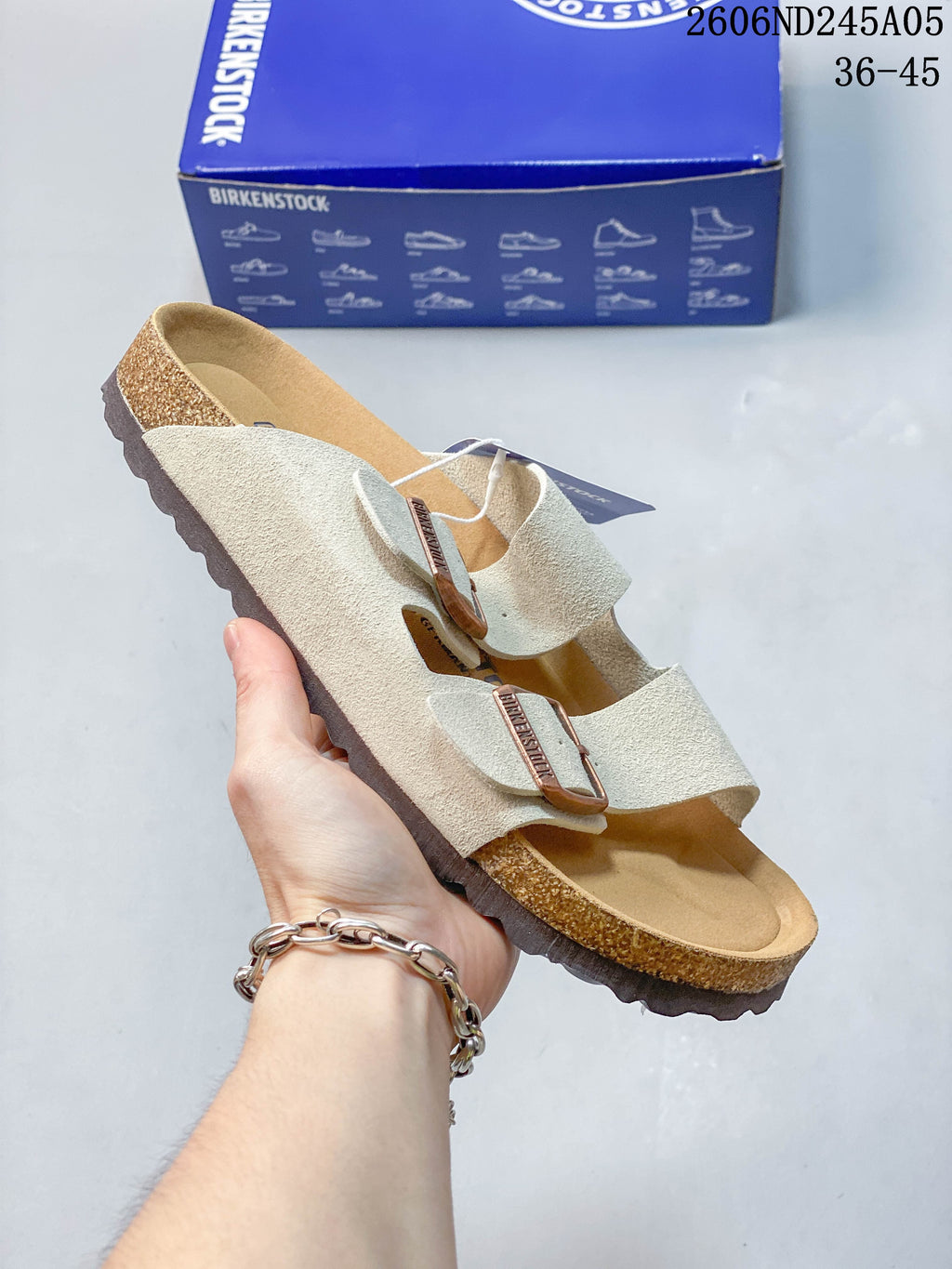 Pale neutral two-strap sandal with contoured footbed.