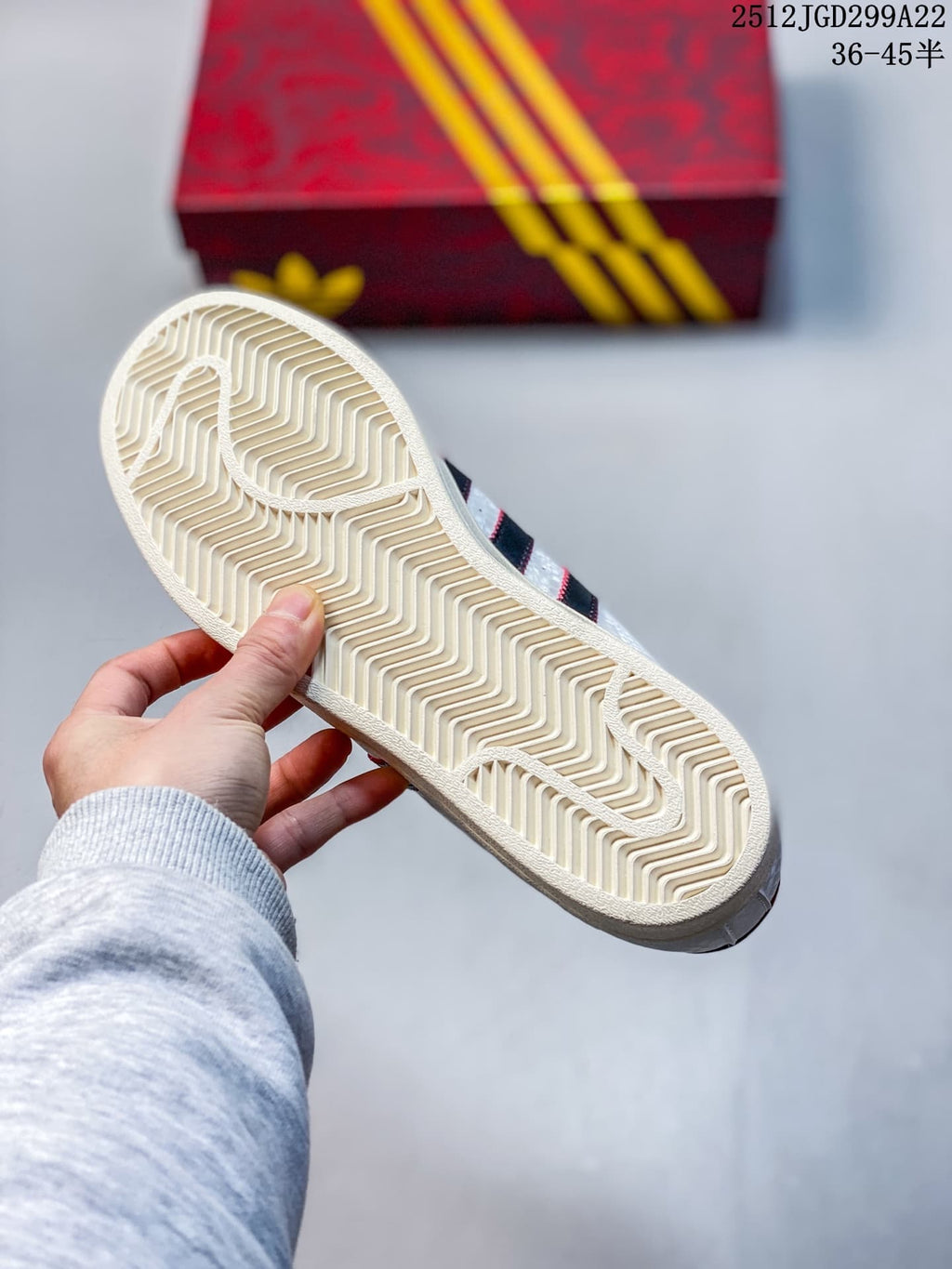 Close-up of the cream-colored patterned outsole on a white Adidas Superstar sneaker