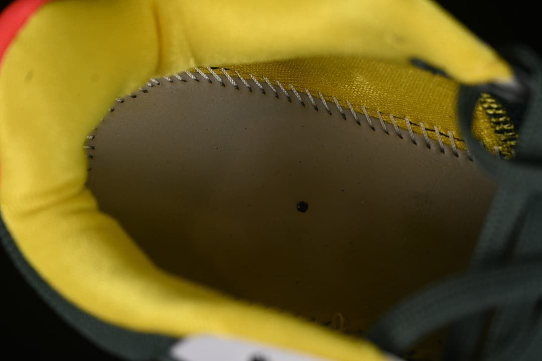 Close-up inside the shoe showing yellow lining and interior stitching