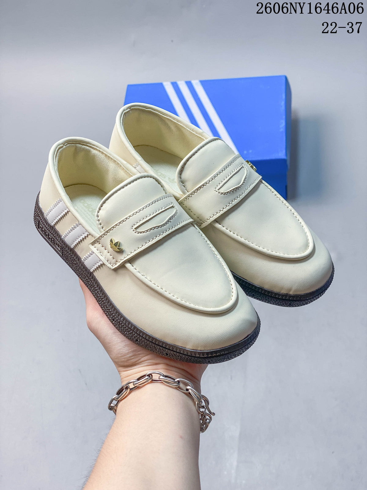 Pair of cream Adidas Handball Spezial loafer-style shoes with dark gum-look soles