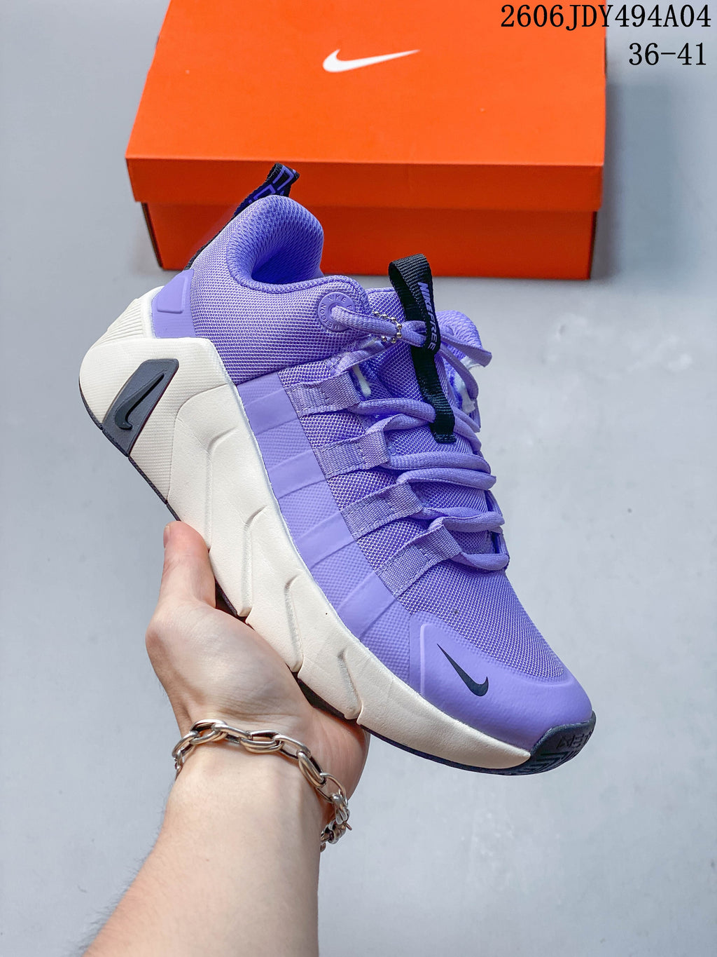 Angled view of the purple Nike training shoe, showing its mesh upper and contrasting sole.
