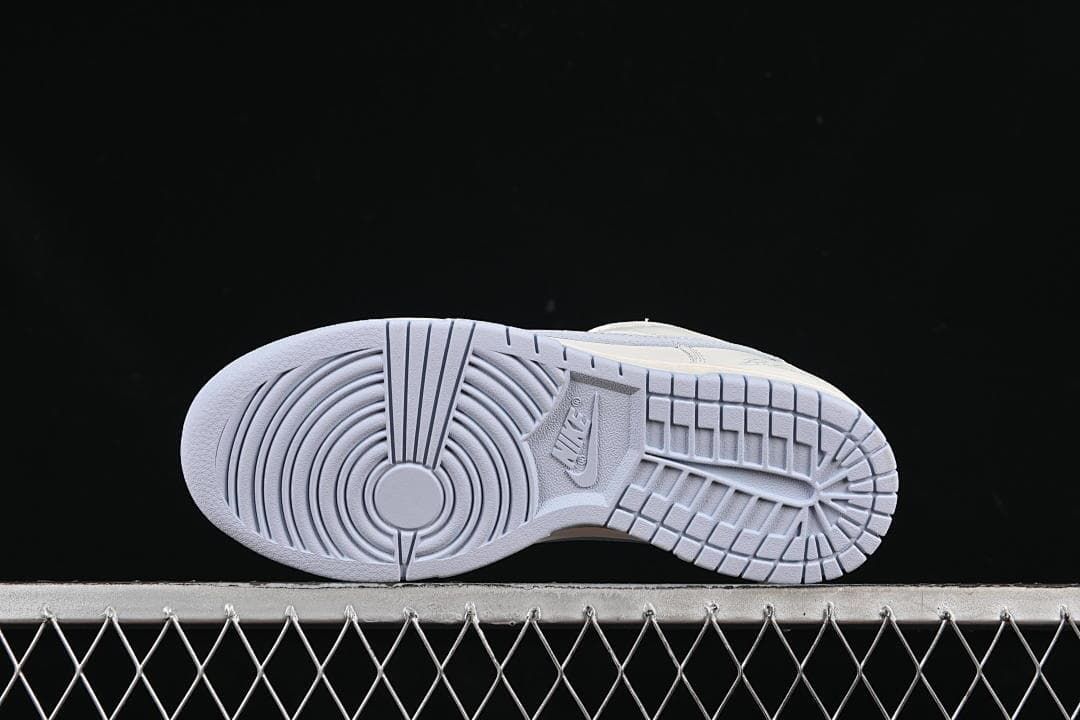 Underside view showing the tread pattern and light blue outsole