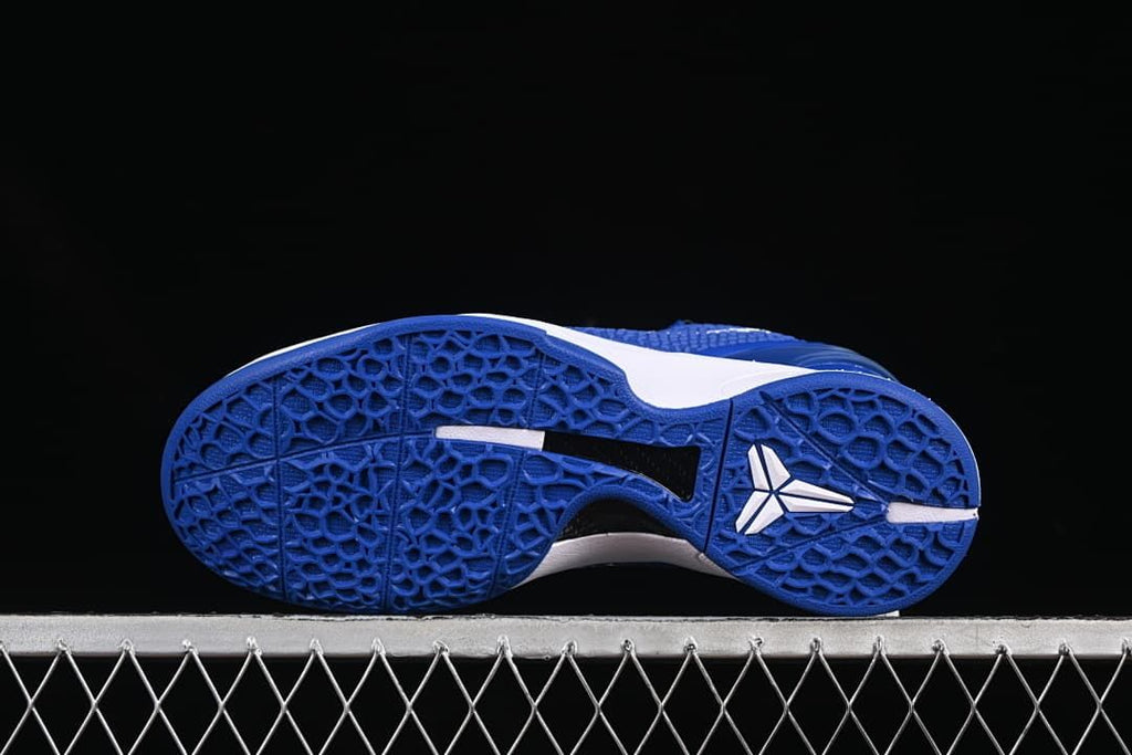 Underside view showing the blue patterned outsole and white Kobe logo