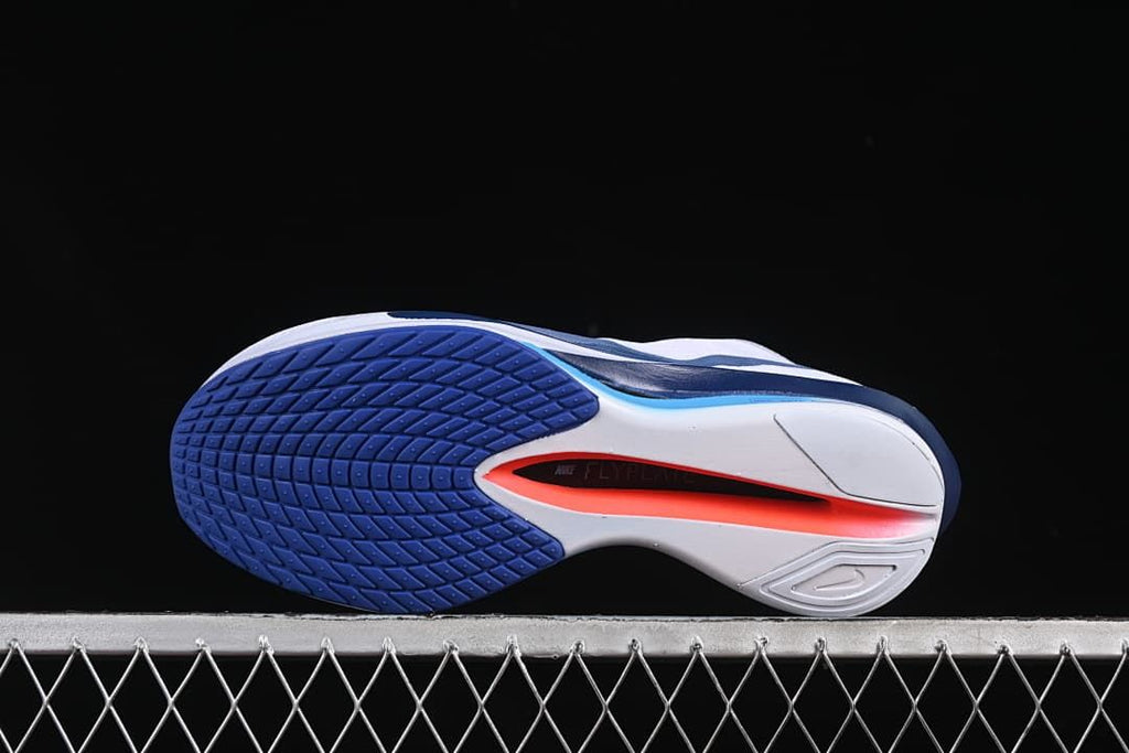 Underside view showing the patterned blue outsole and sculpted sole
