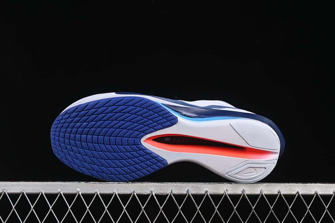Underside view showing the patterned blue outsole and sculpted sole