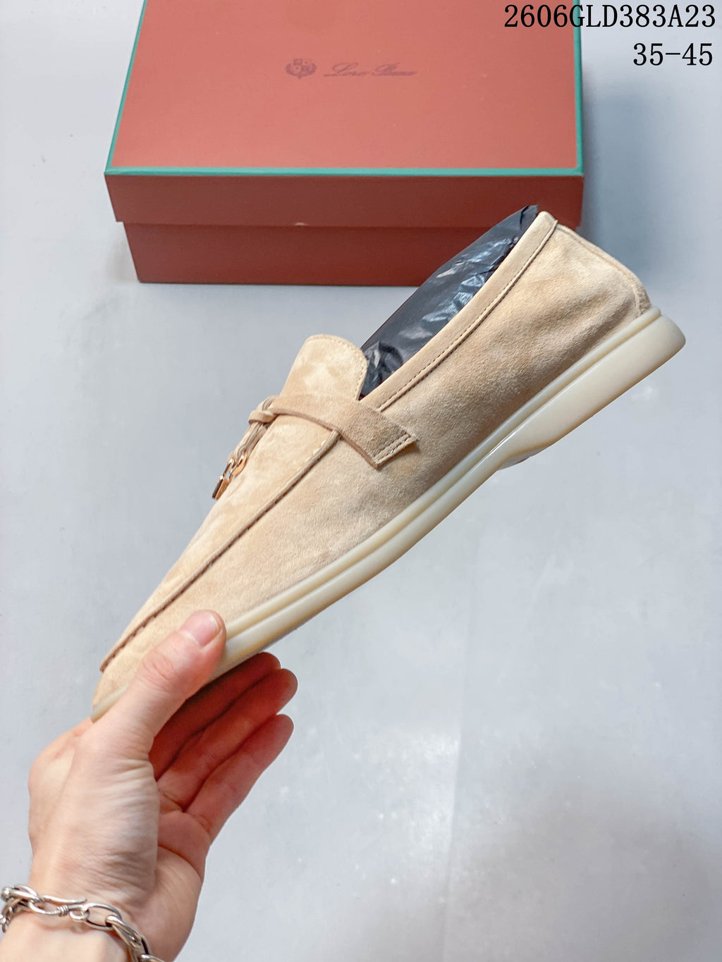 Side profile of a beige slip-on loafer with a light-colored sole