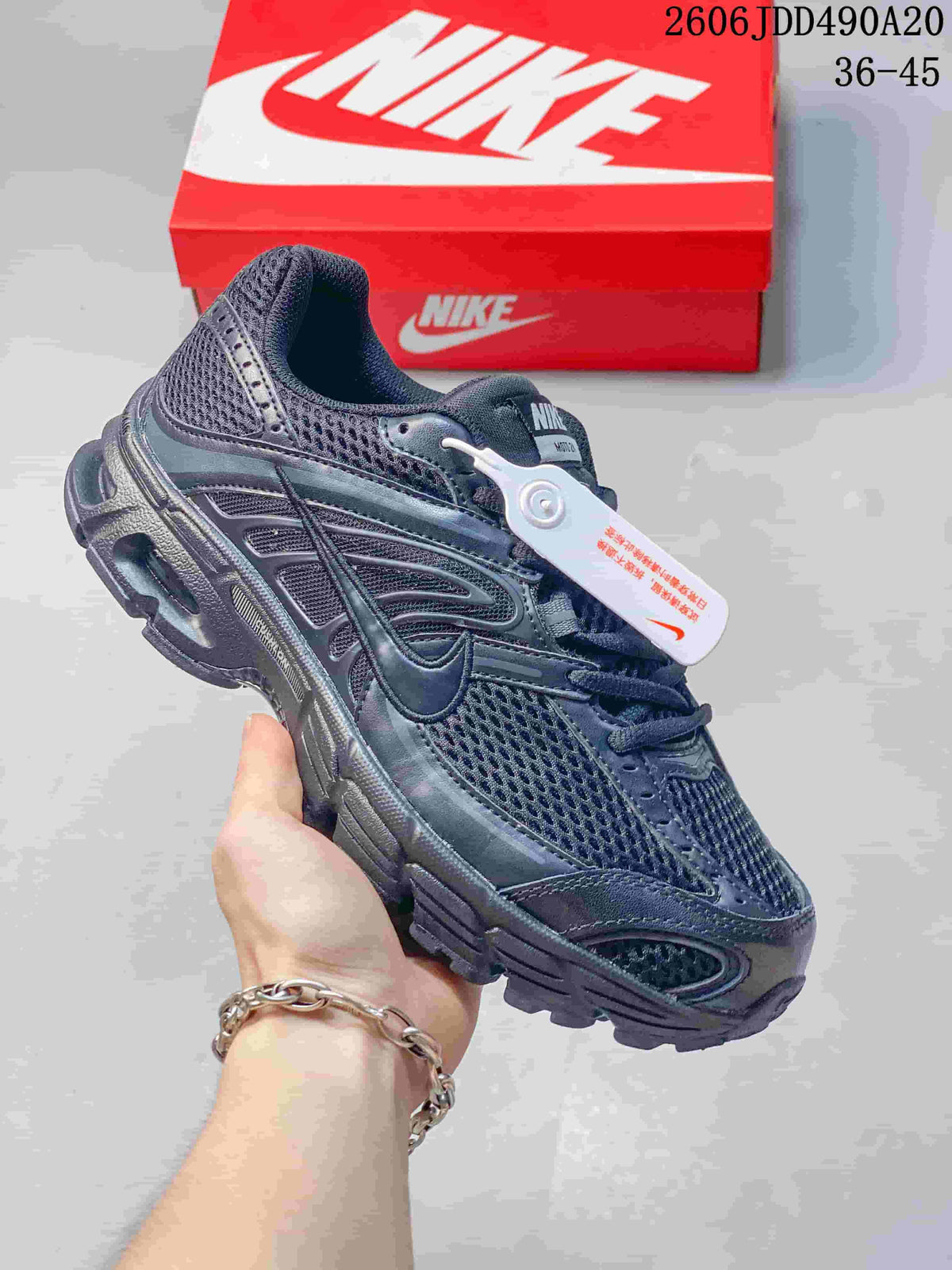 Dark navy Nike Air Max Moto 2K sneaker with pale Swoosh detail