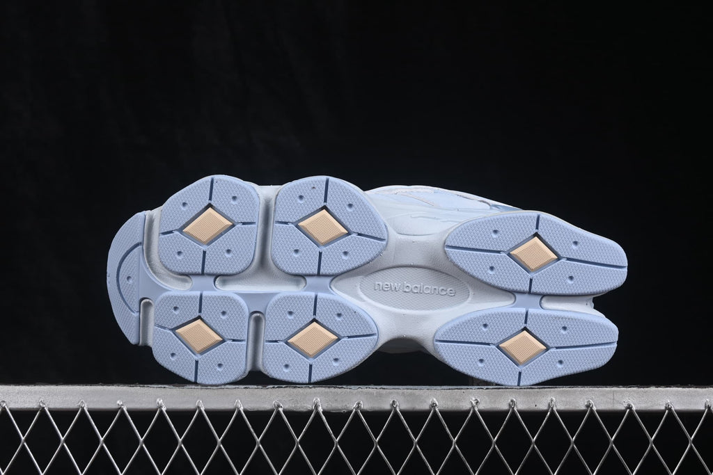 Underside view showing the segmented light blue outsole and tan-colored traction inserts.