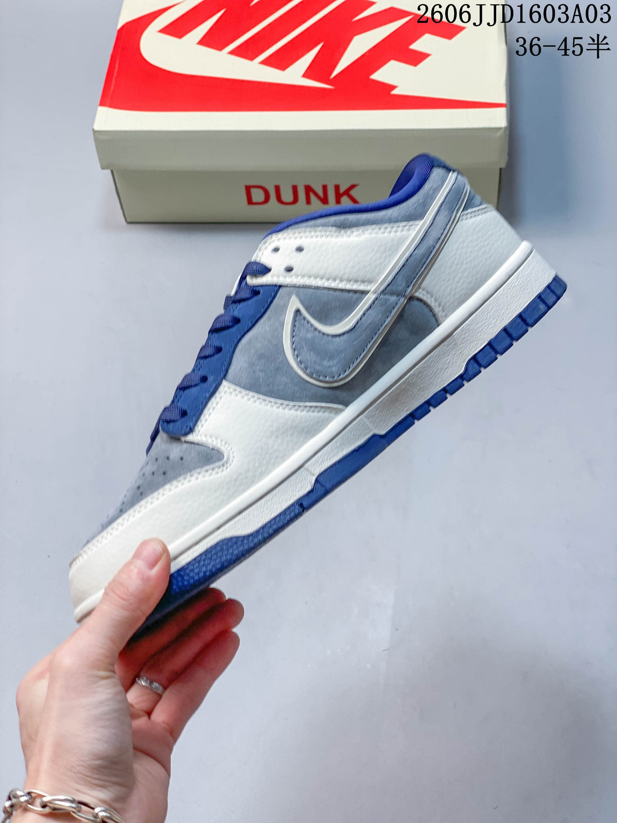 Side profile showing the blue-grey overlays, contrasting Swoosh, and low-top shape