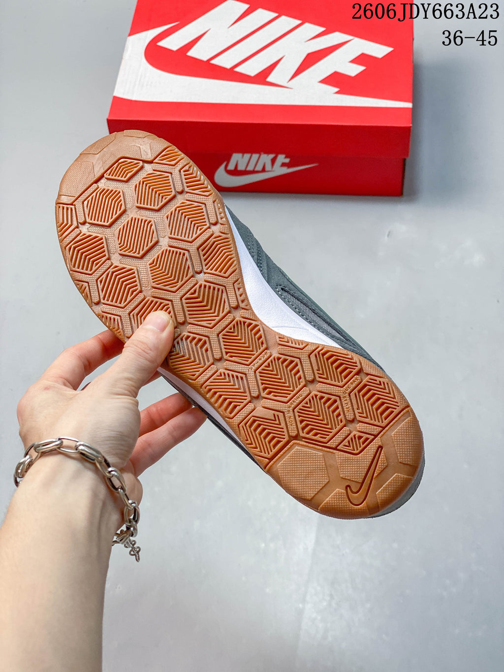 Close-up of the gum-colored outsole tread on a gray Nike Gato sneaker