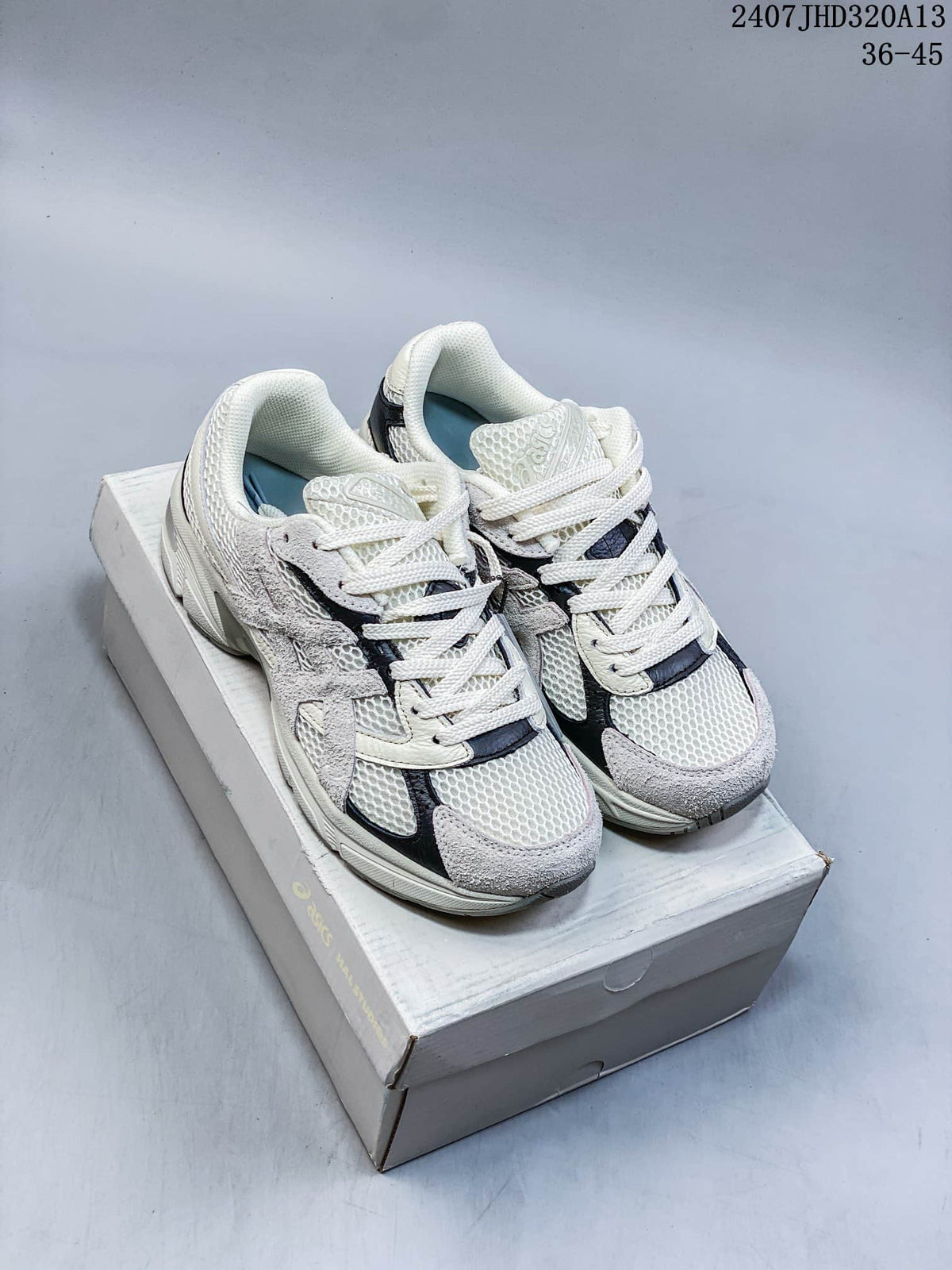 Pair of cream, gray, and dark-accent ASICS GEL-1130 sneakers shown from above