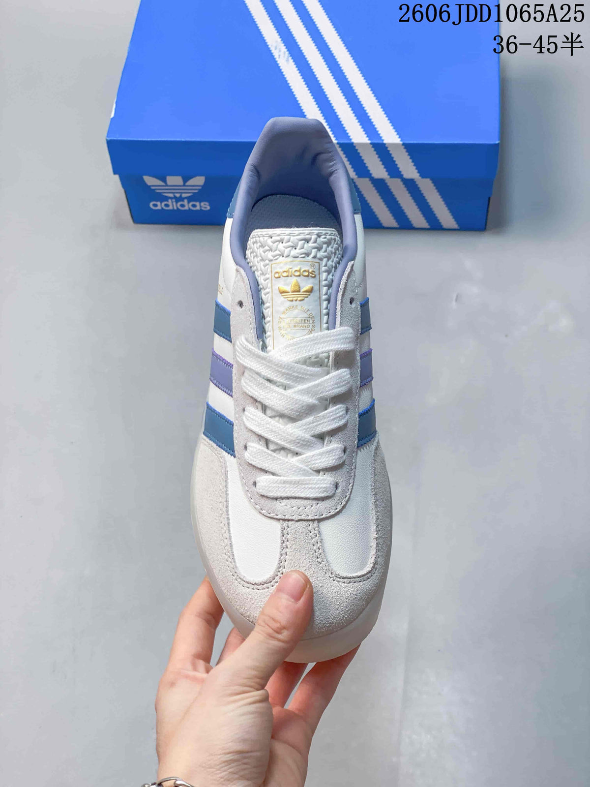 Top view showing the white laces, light-gray overlays, and blue-and-lavender stripes.
