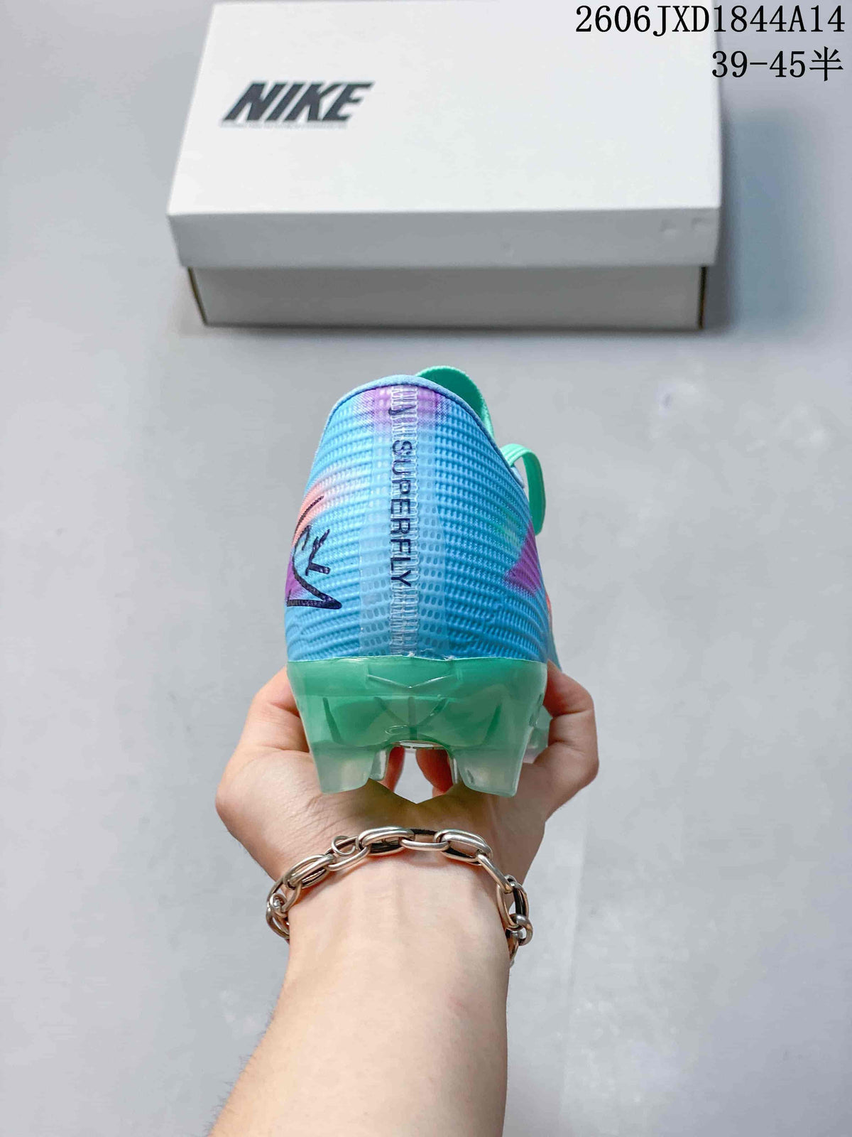 Rear view showing the blue patterned heel, green outsole, and studs.