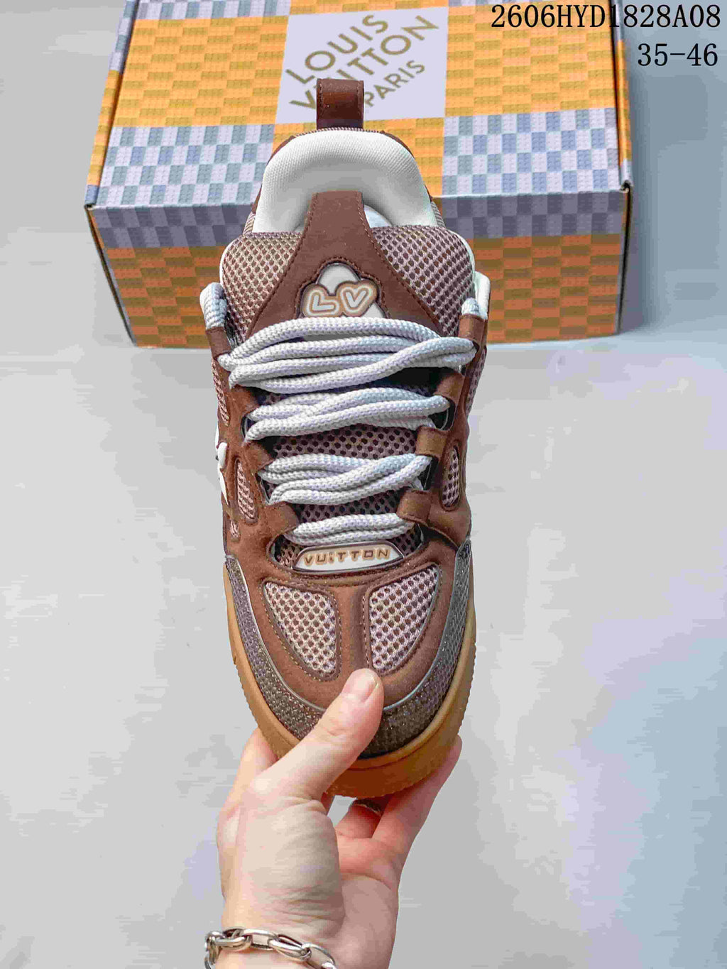 Top view of a brown Louis Vuitton Trainer sneaker with thick white laces and mesh panels