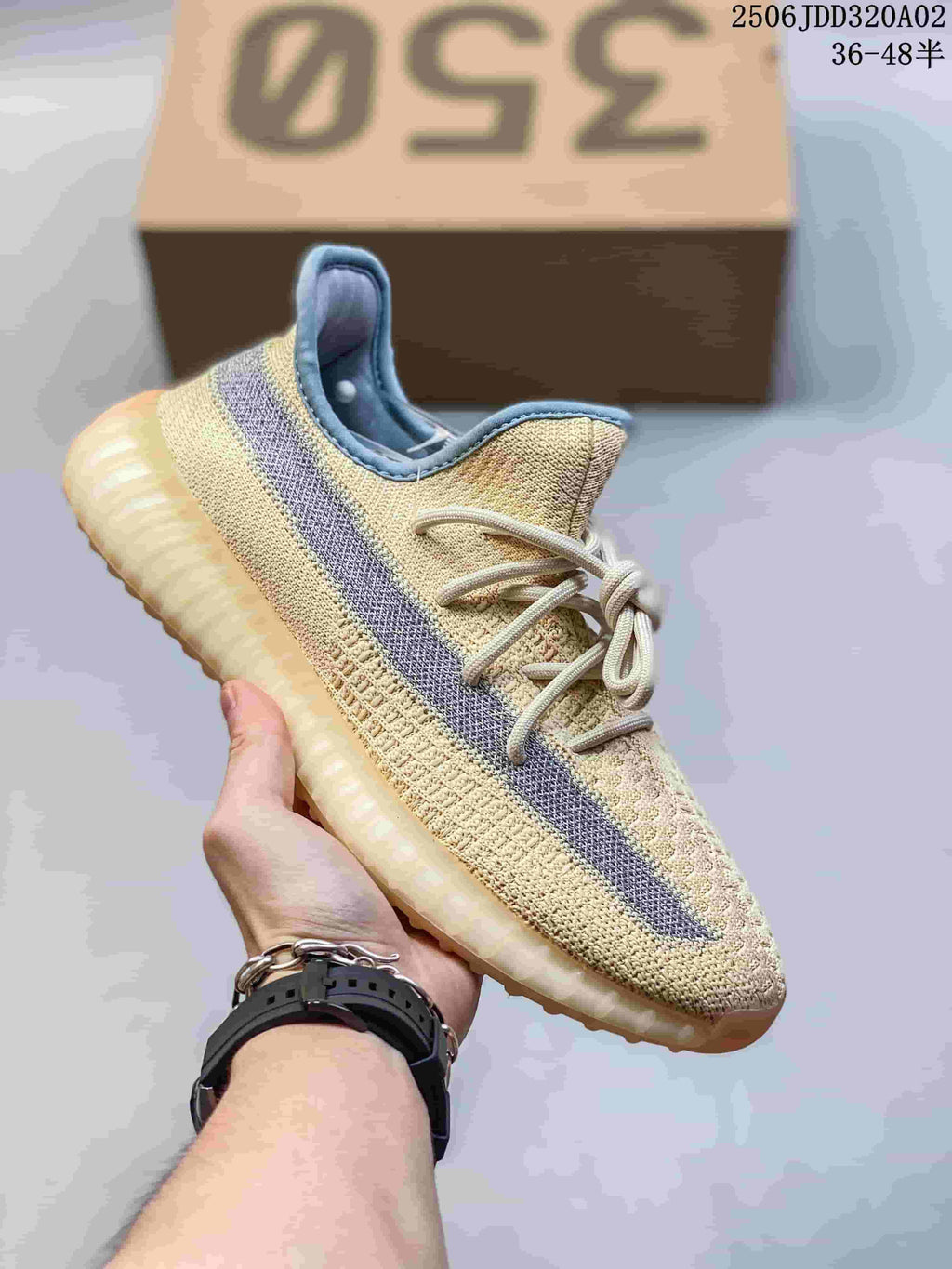 Light tan knit-look Adidas Yeezy-style sneaker with a contrasting side stripe and ribbed sole
