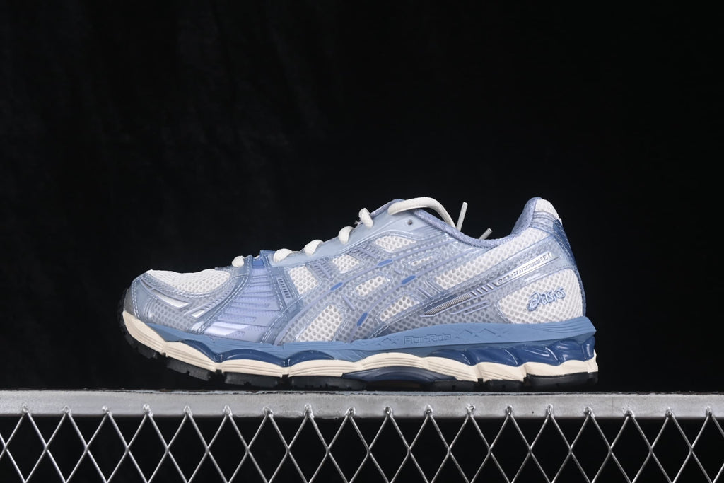 Side profile of the cream and light blue ASICS Gel-Kayano 12.1 sneaker with layered mesh panels and a segmented sole.
