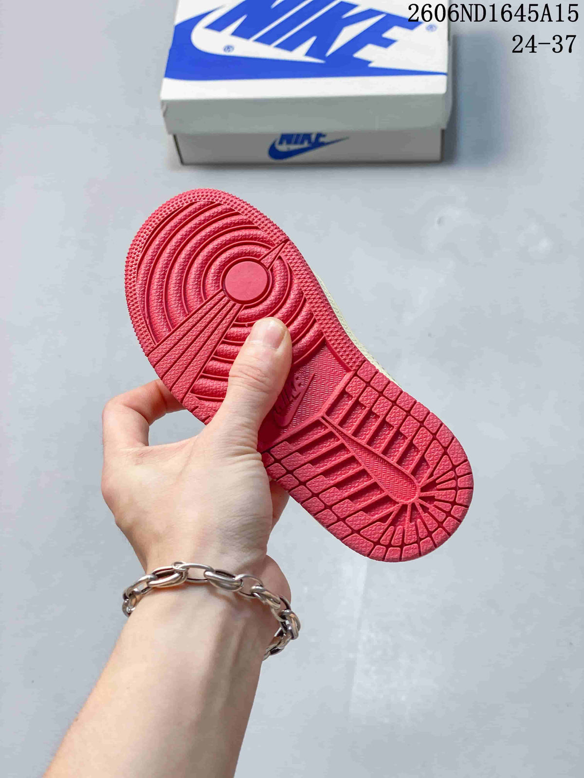 Close-up of the red patterned outsole on the kids’ low-top sneaker