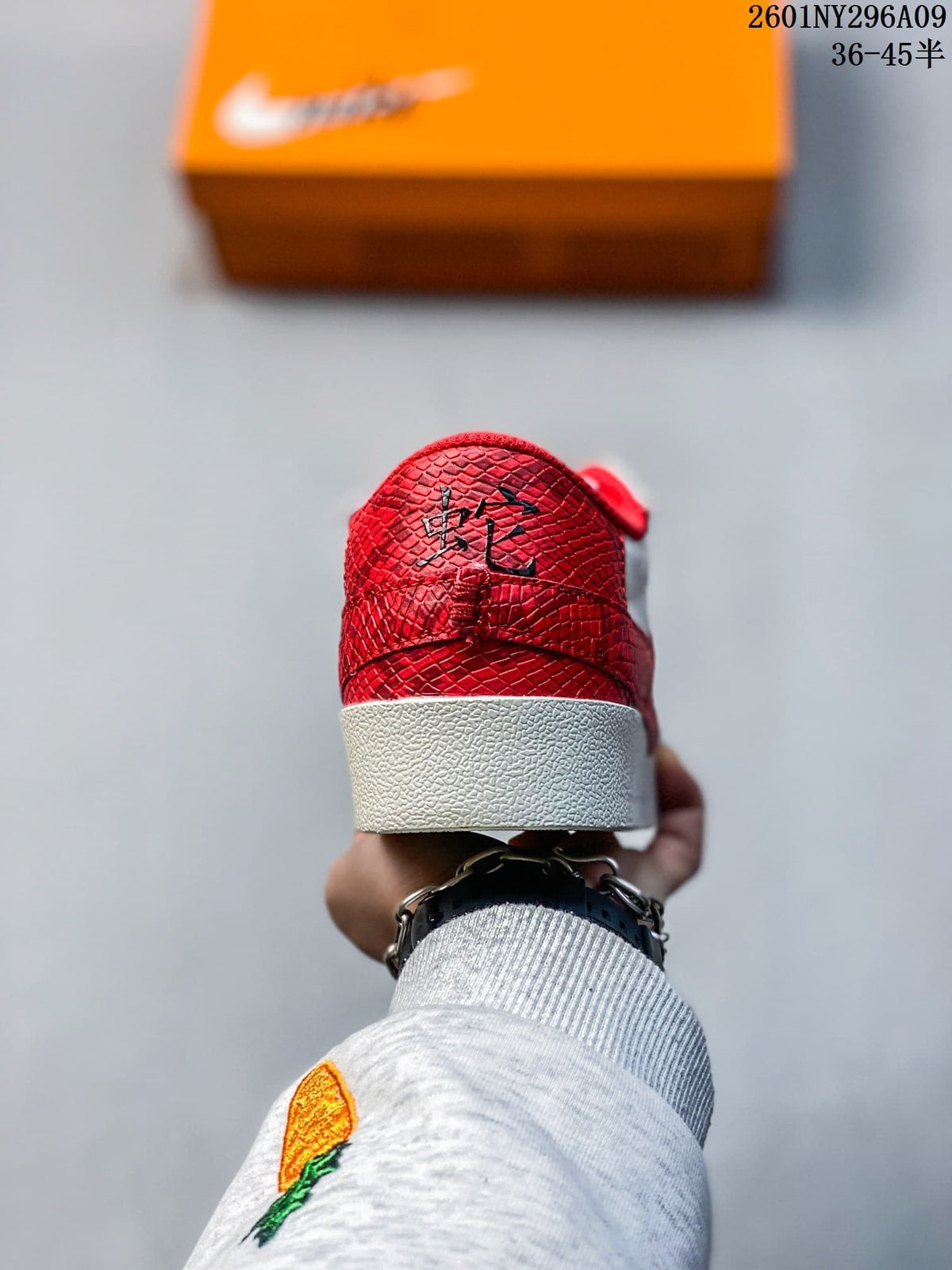 Rear view showing the red textured heel panel and white midsole