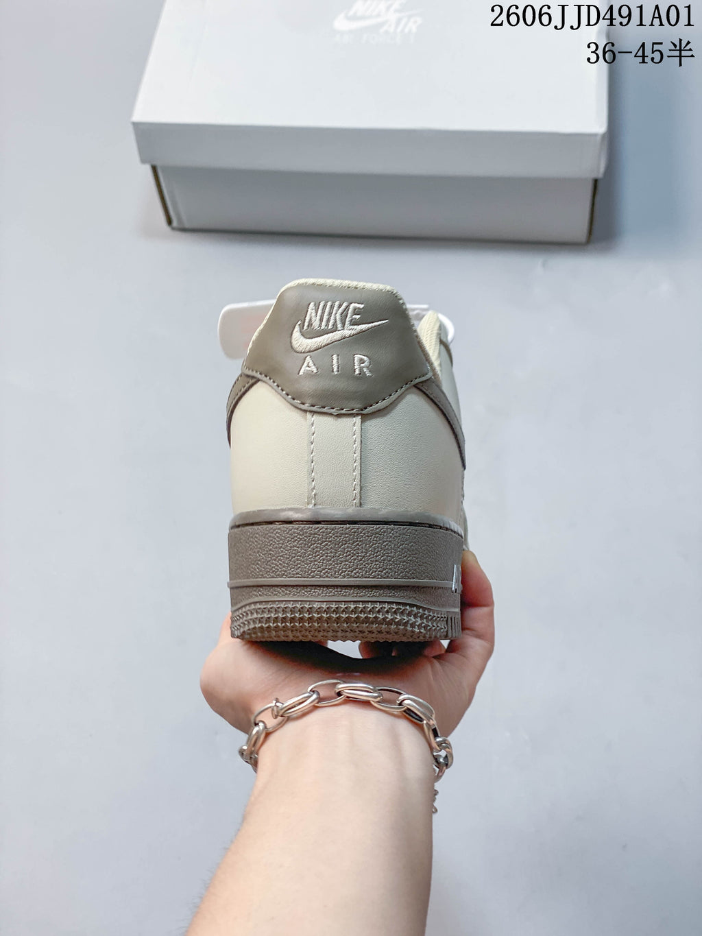 Rear view showing the heel panel and layered taupe sole