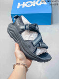 Dark gray HOKA Infini Hike TC sandal with adjustable straps and buckle closure