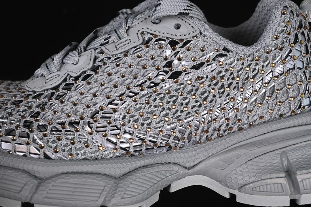 Close-up of the sneaker's openwork upper, reflective-looking accents, and gold-tone details.