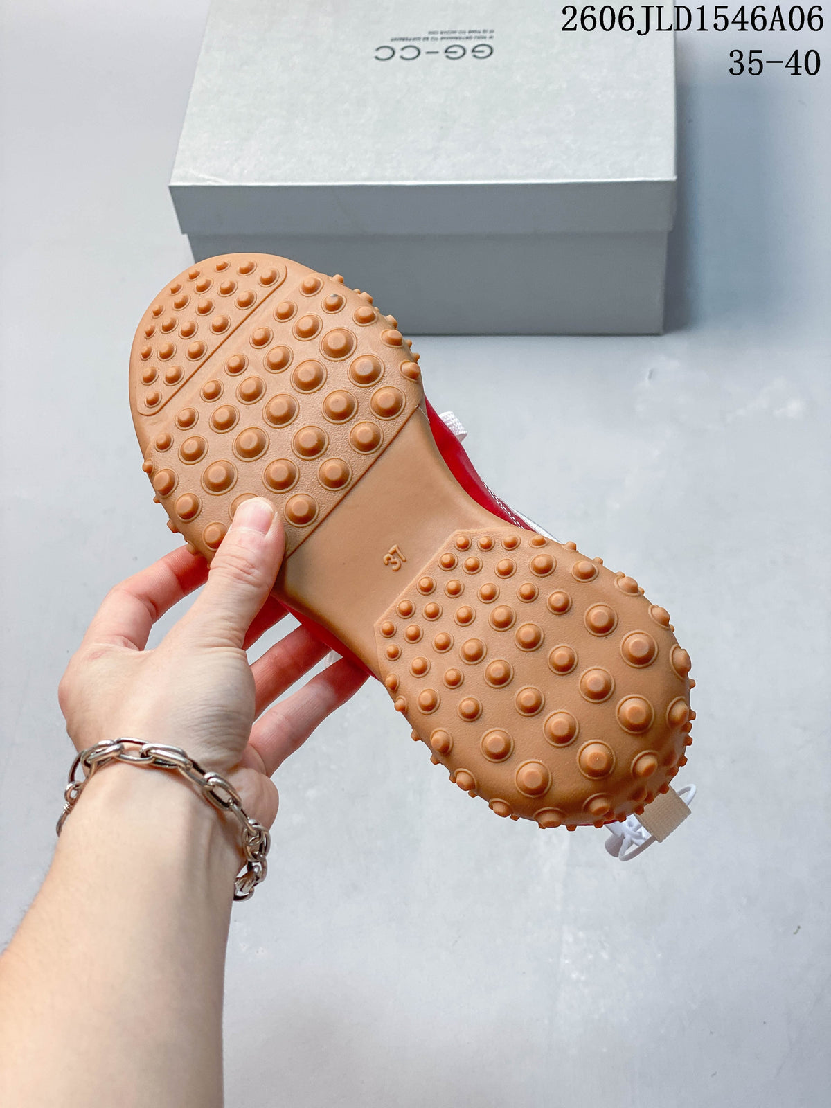 Close-up of the gum-colored sneaker outsole with raised round tread.