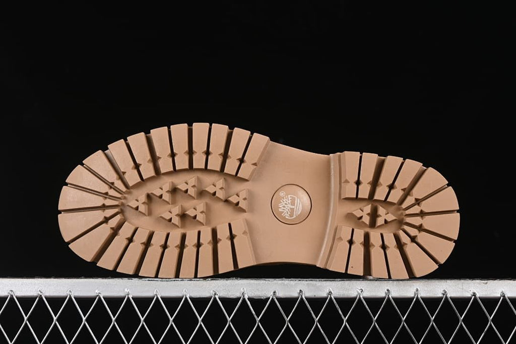 Underside of the boot showing a deeply lugged outsole