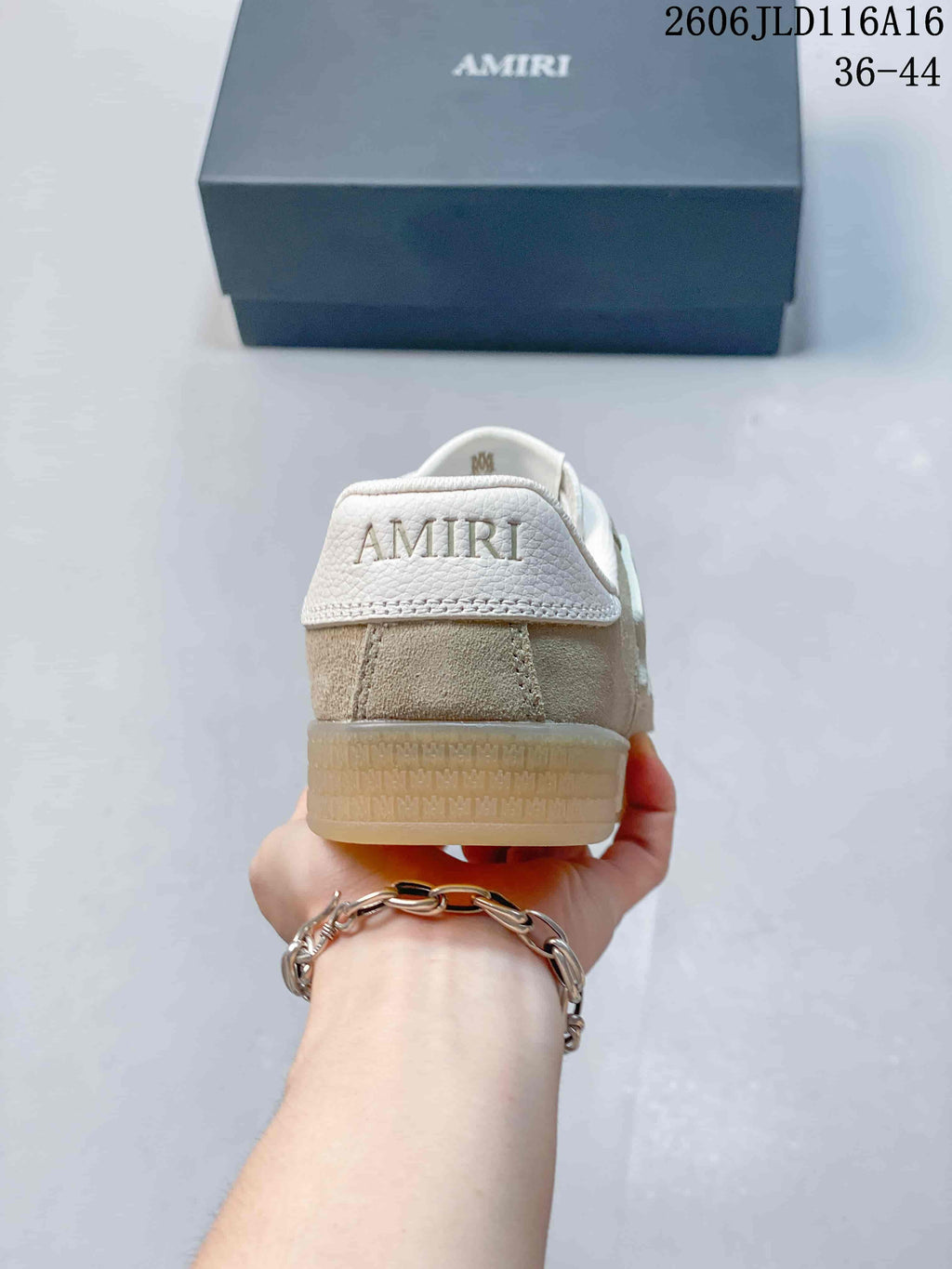 Rear view showing the AMIRI-branded heel panel and translucent gum-colored sole.